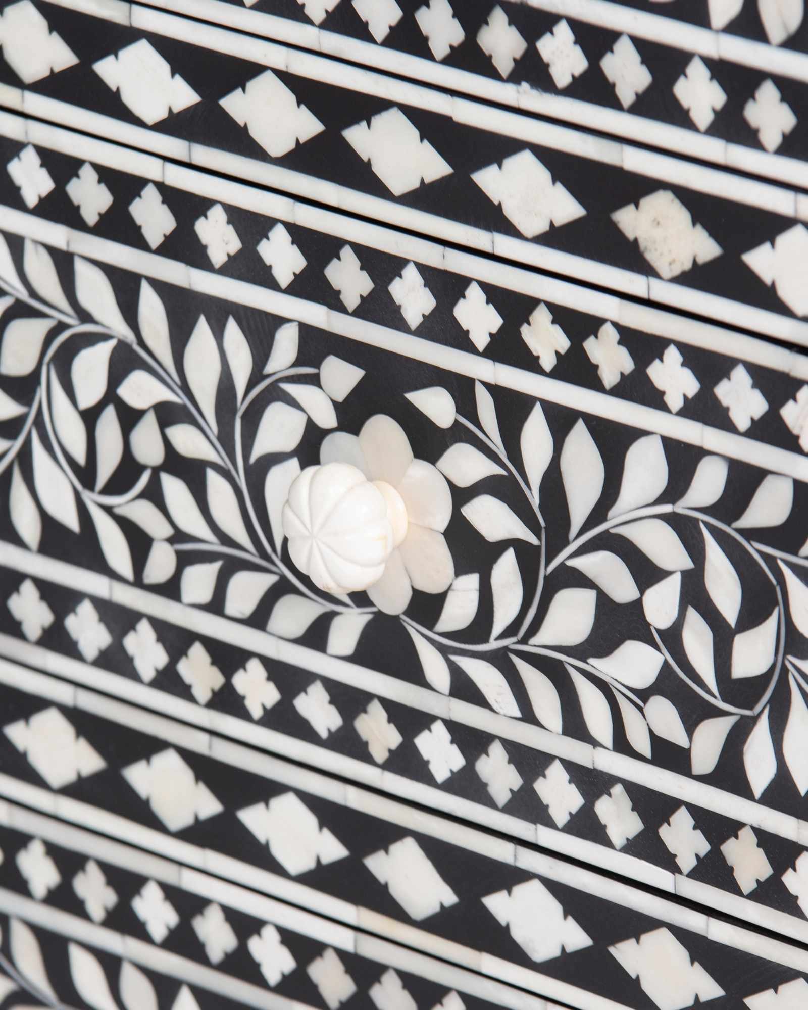 Bone inlay chest of drawers featuring intricate floral pattern in black and white, handcrafted furniture piece.