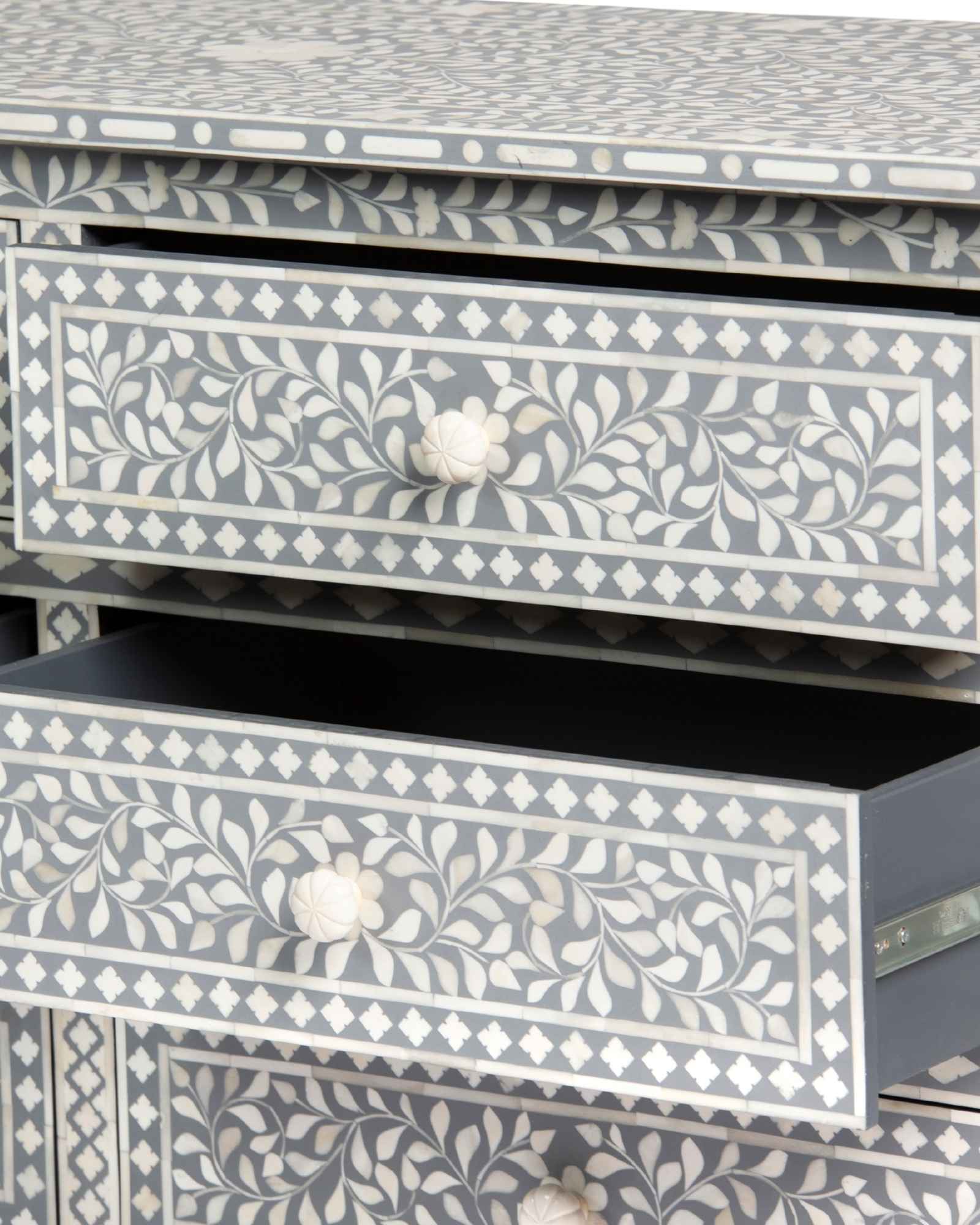 Bone inlay chest of drawers featuring intricate floral pattern in grey and white, handcrafted furniture piece.