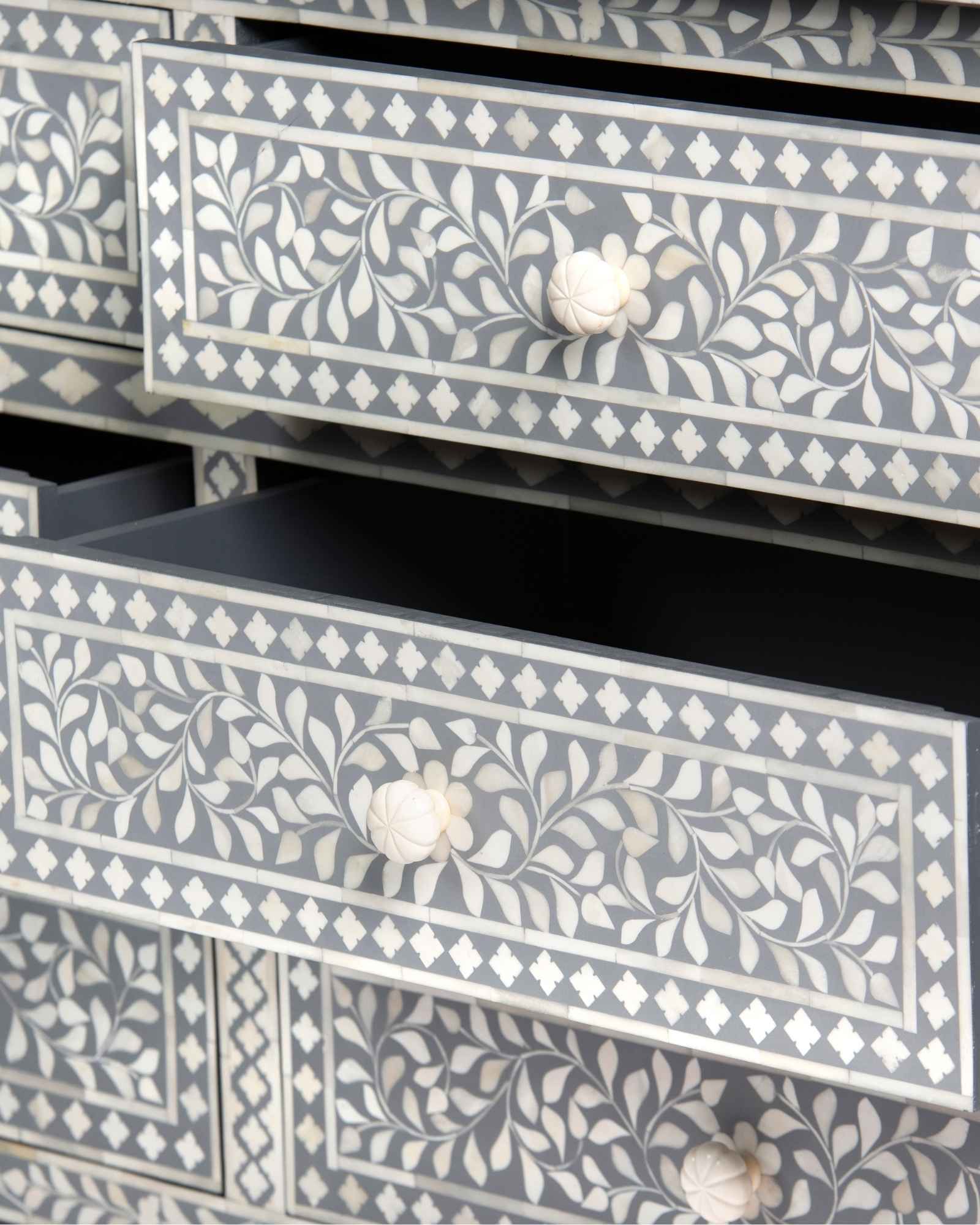 Bone inlay chest of drawers featuring intricate floral pattern in grey and white, handcrafted furniture piece.