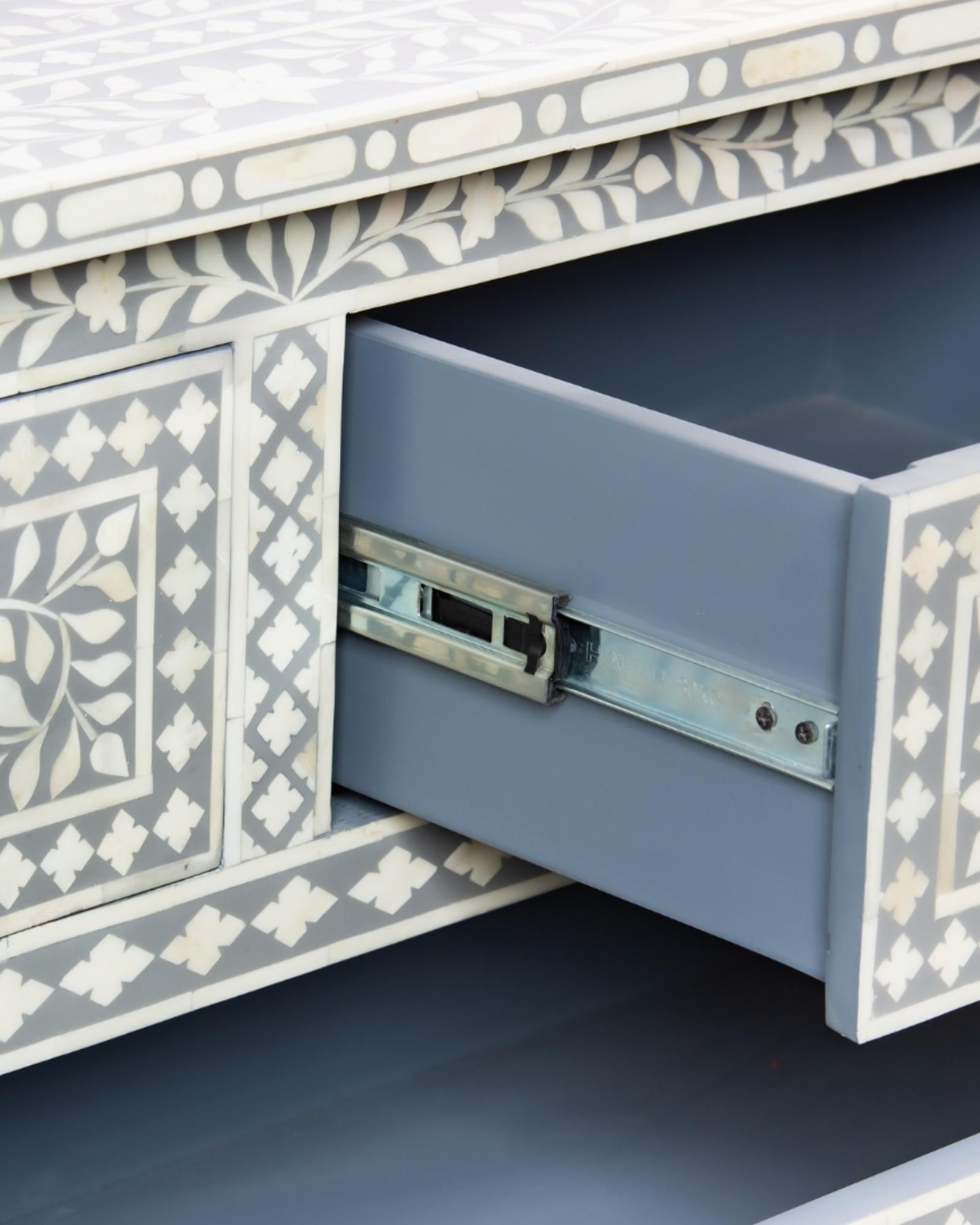 Featuring a Grey Bone Inlay Chest of Drawer in floral pattern, the Jade collection enhances your space with intricately handcrafted designs that elevate your home and living aesthetics. 