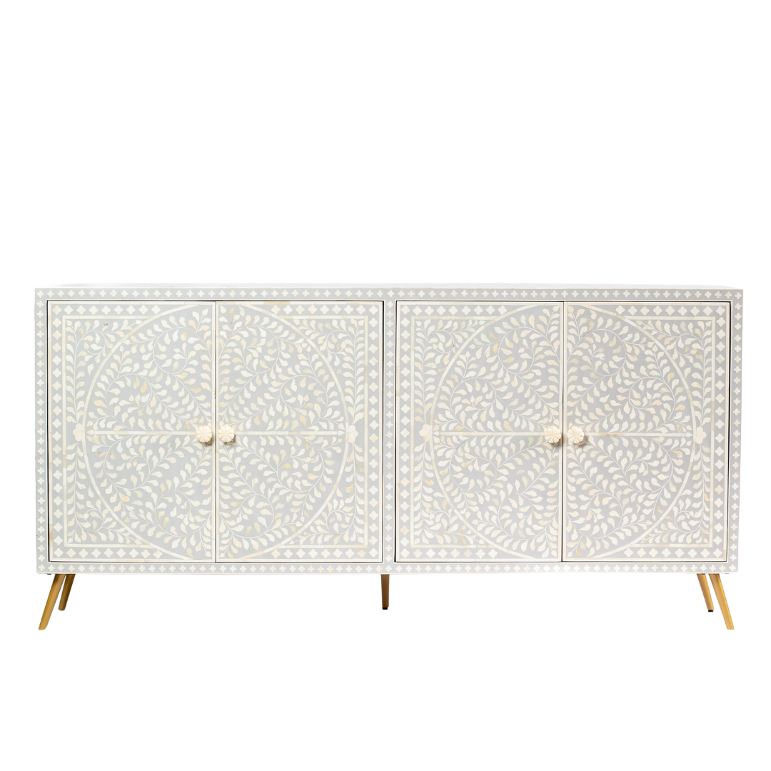 Grey bone inlay cabinet with floral vine pattern, brass legs, and carved bone knobs, handcrafted with spacious storage and artisanal charm.