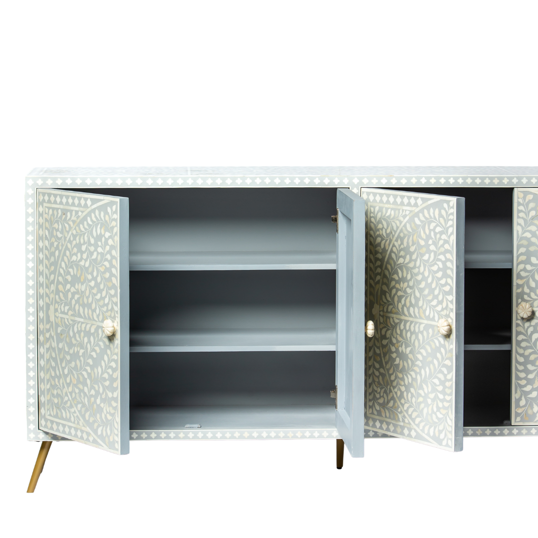 Grey bone inlay cabinet with floral vine pattern, brass legs, and carved bone knobs, handcrafted with spacious storage and artisanal charm.