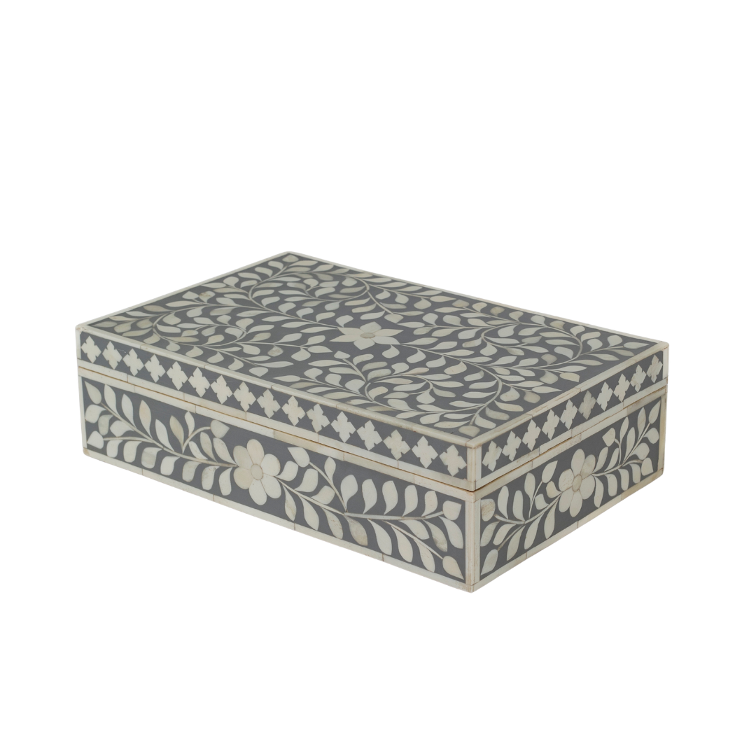 A soft grey decorative box crafted in bone inlay, combining subtle tones with intricate floral detailing.