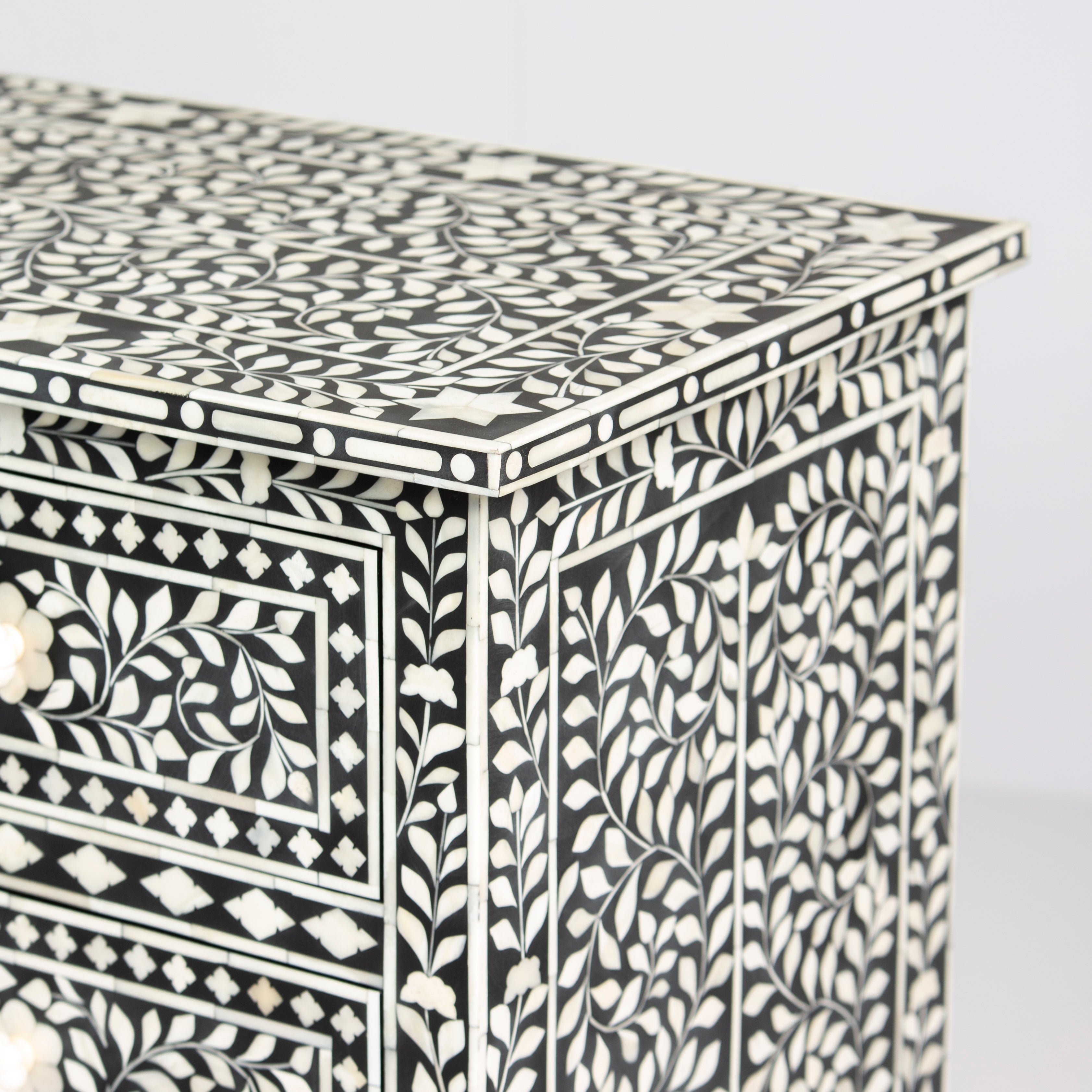 Bone inlay chest of drawers featuring intricate floral pattern in black and white, handcrafted furniture piece