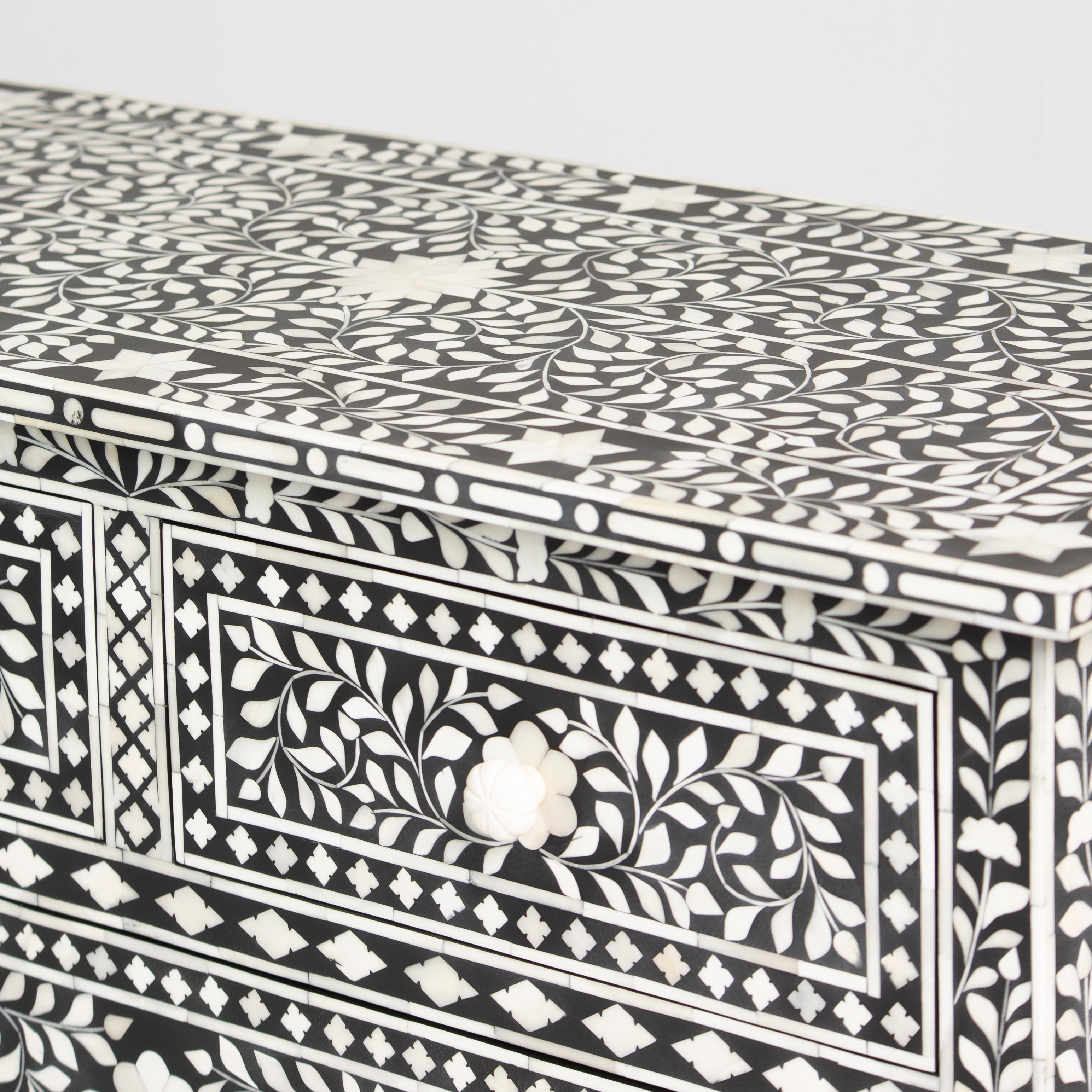 Bone inlay chest of drawers featuring intricate floral pattern in black and white, handcrafted furniture piece