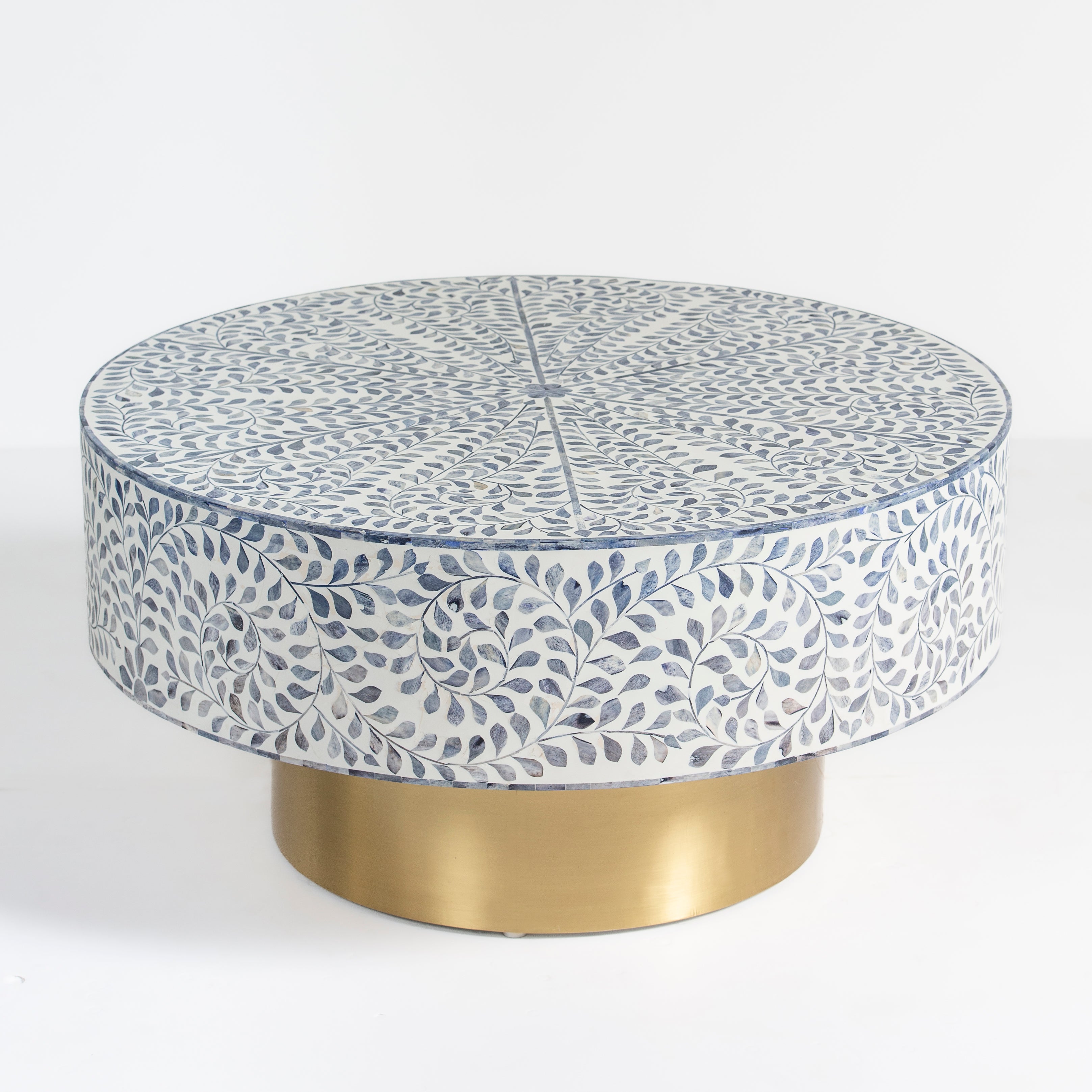 Handcrafted Jade coffee table featuring intricate blue bone inlay detailing with a round silhouette and brushed brass base.
