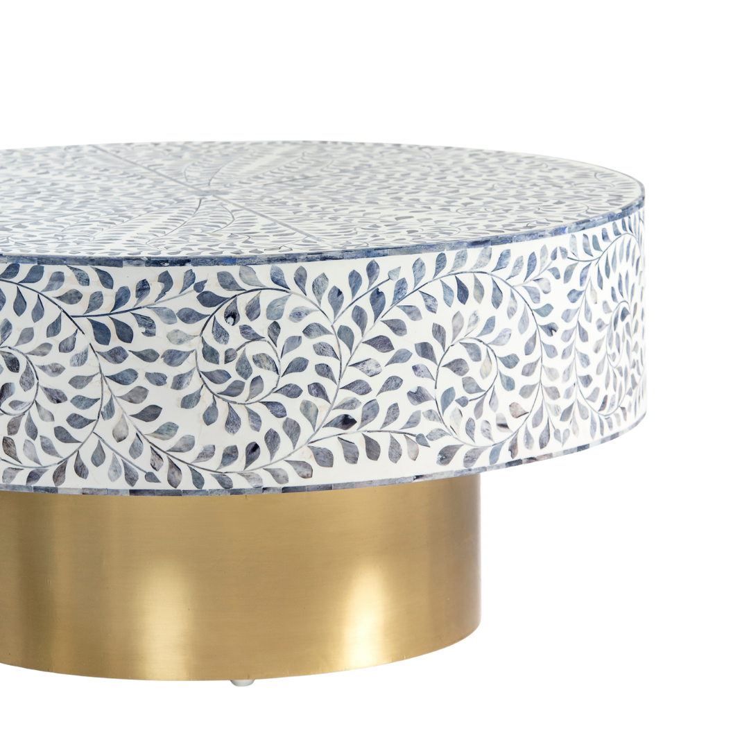 Handcrafted Jade coffee table featuring intricate blue bone inlay detailing with a round silhouette and brushed brass base.