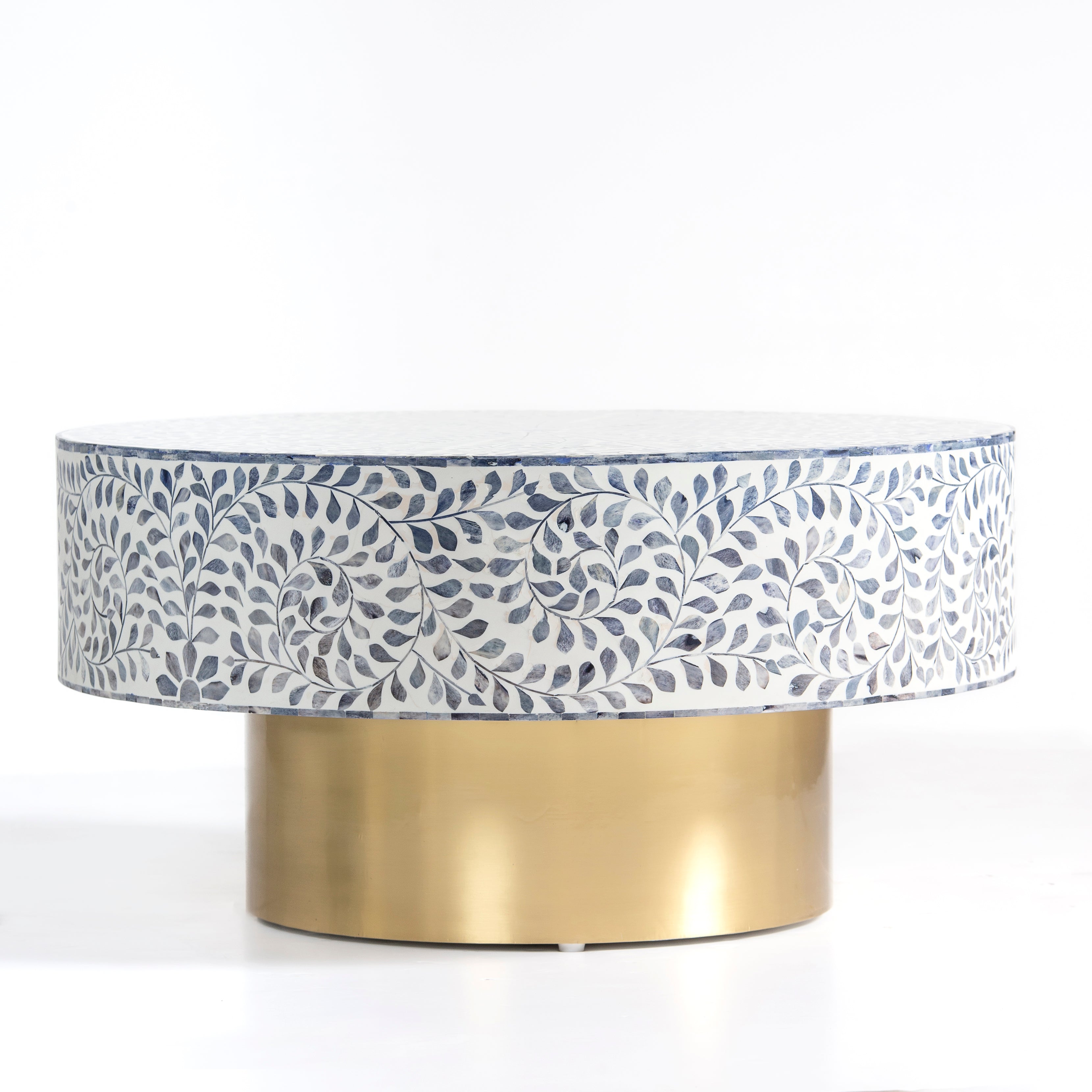 Handcrafted Jade coffee table featuring intricate blue bone inlay detailing with a round silhouette and brushed brass base.