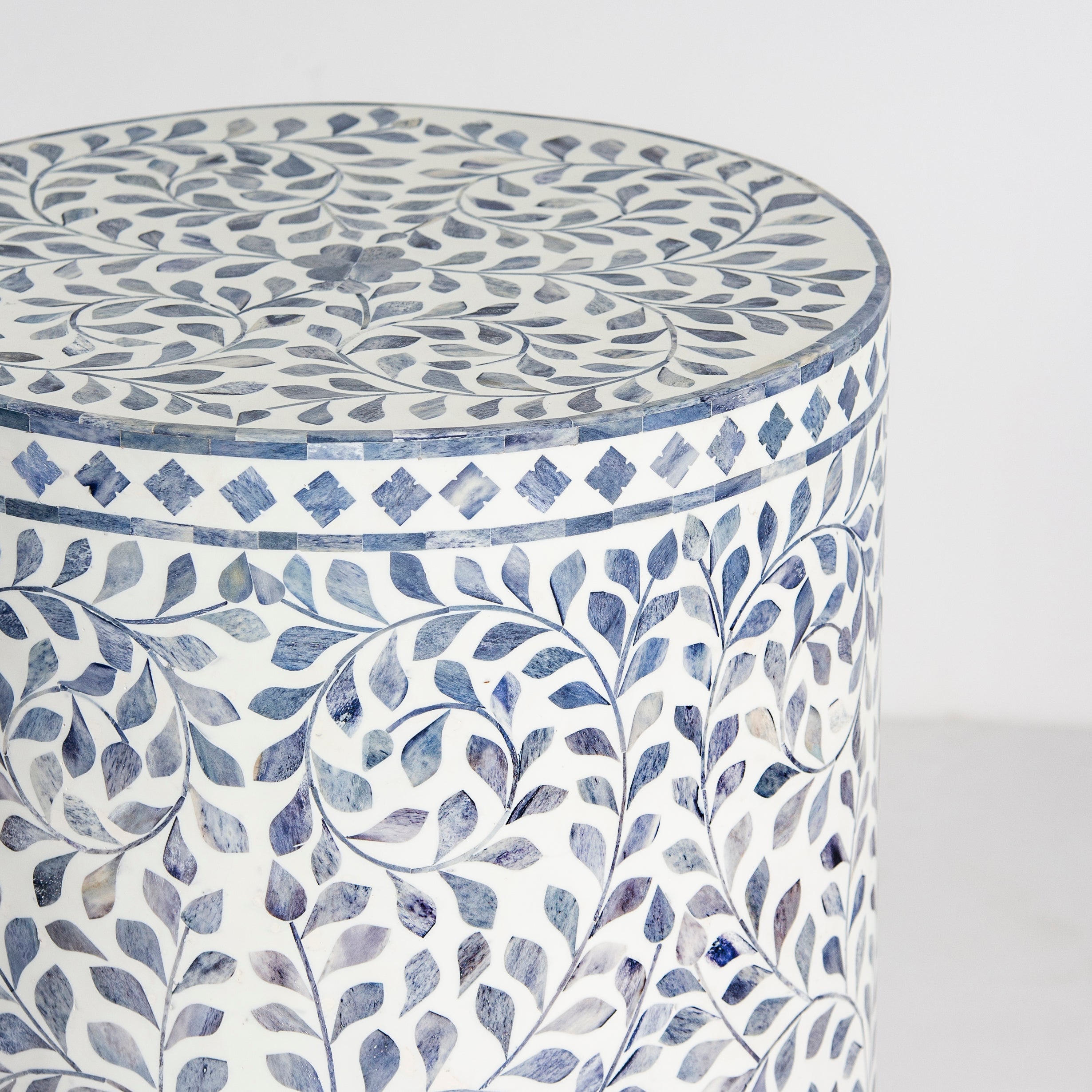Handcrafted Jade side table featuring intricate blue bone inlay with a cylindrical silhouette and refined artisanal detailing.