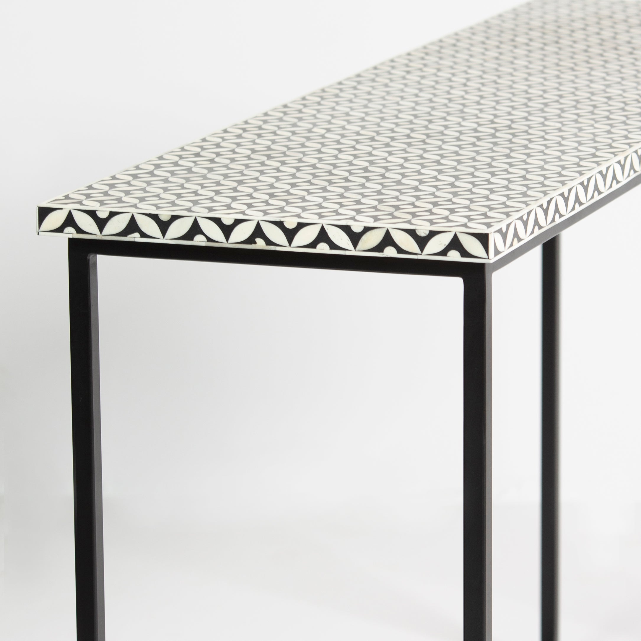 Bone inlay console table featuring geometric pattern in black and white with metal base, handcrafted furniture piece