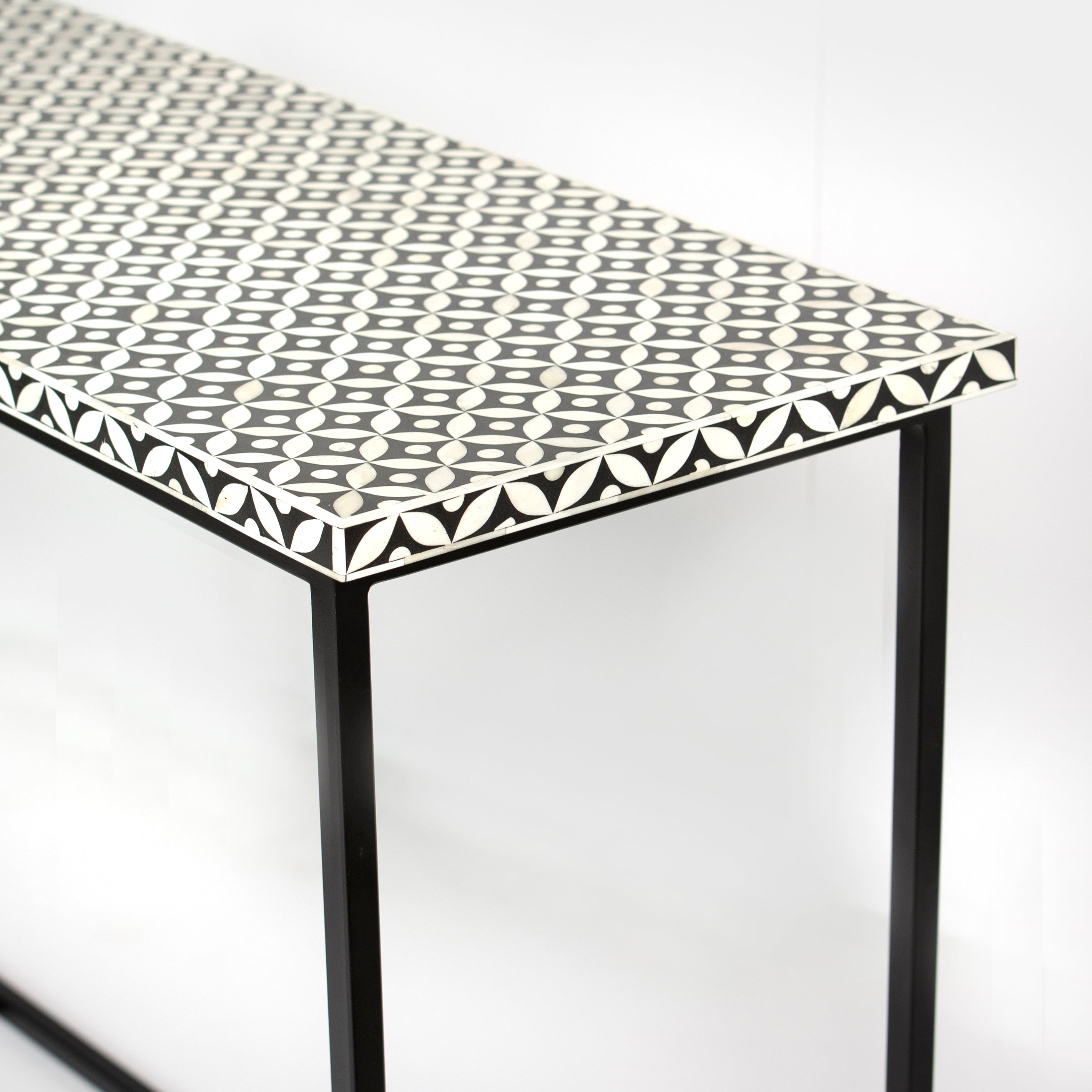 Bone inlay console table featuring geometric pattern in black and white with metal base, handcrafted furniture piece
