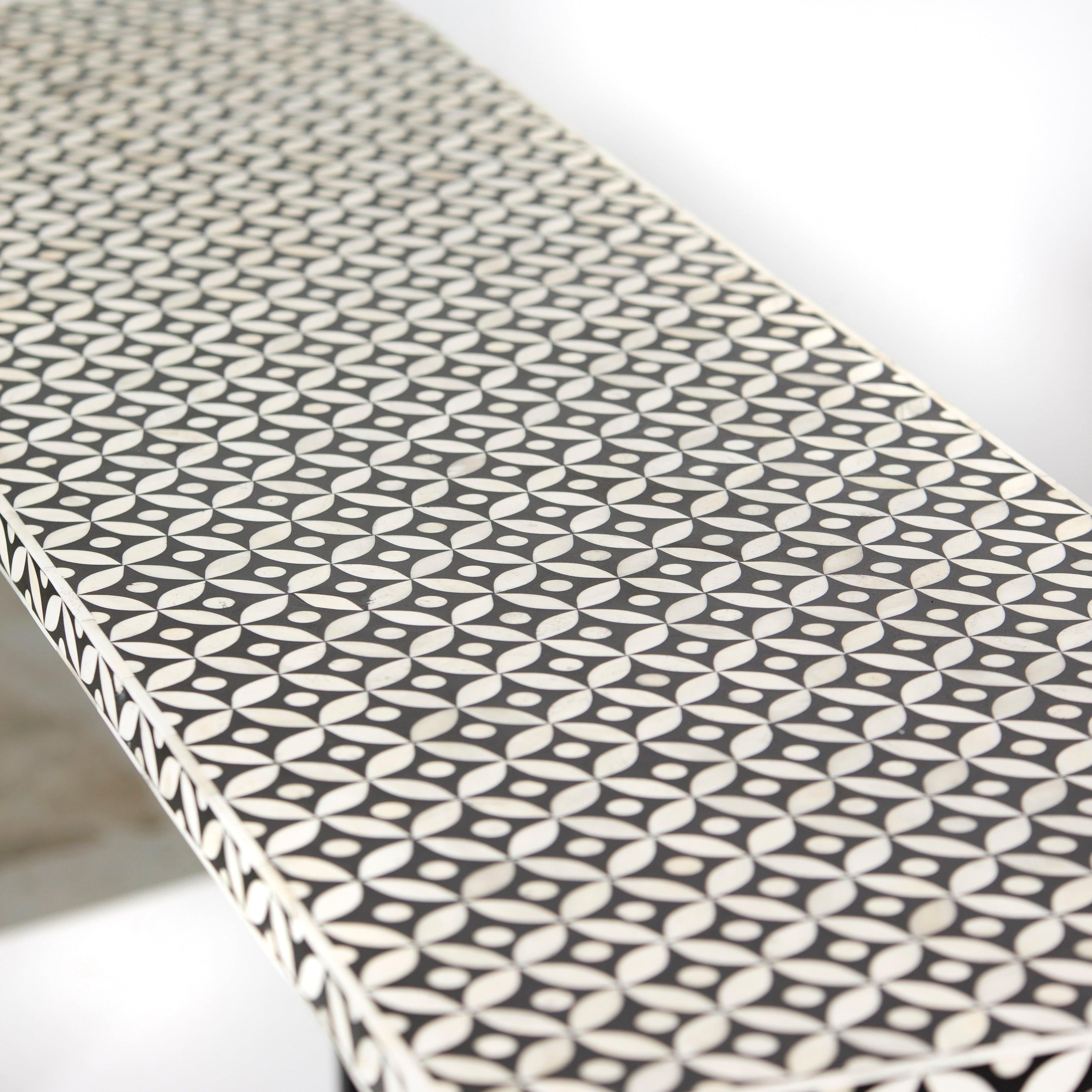 Bone inlay console table featuring geometric pattern in black and white with metal base, handcrafted furniture piece