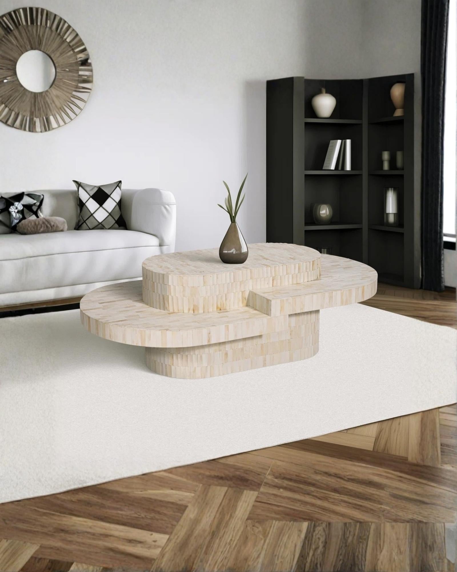 Sculptural bone carved coffee table with layered design in soft neutral tones, handcrafted with curved tiers and textured artisanal detailing.