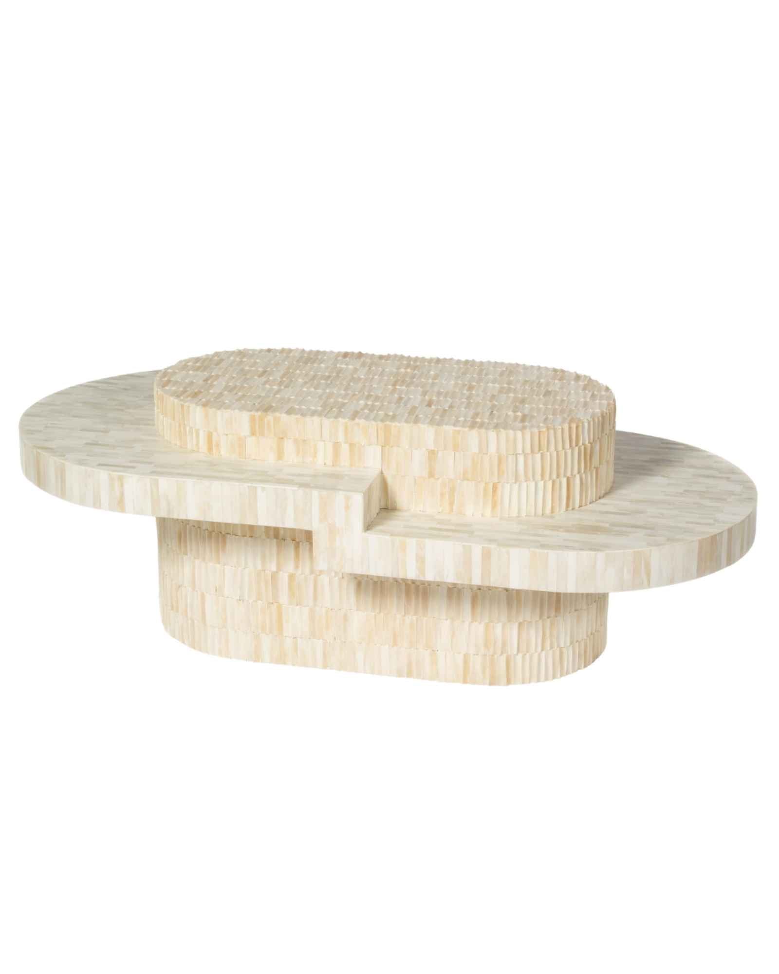 Sculptural bone carved coffee table with layered design in soft neutral tones, handcrafted with curved tiers and textured artisanal detailing.
