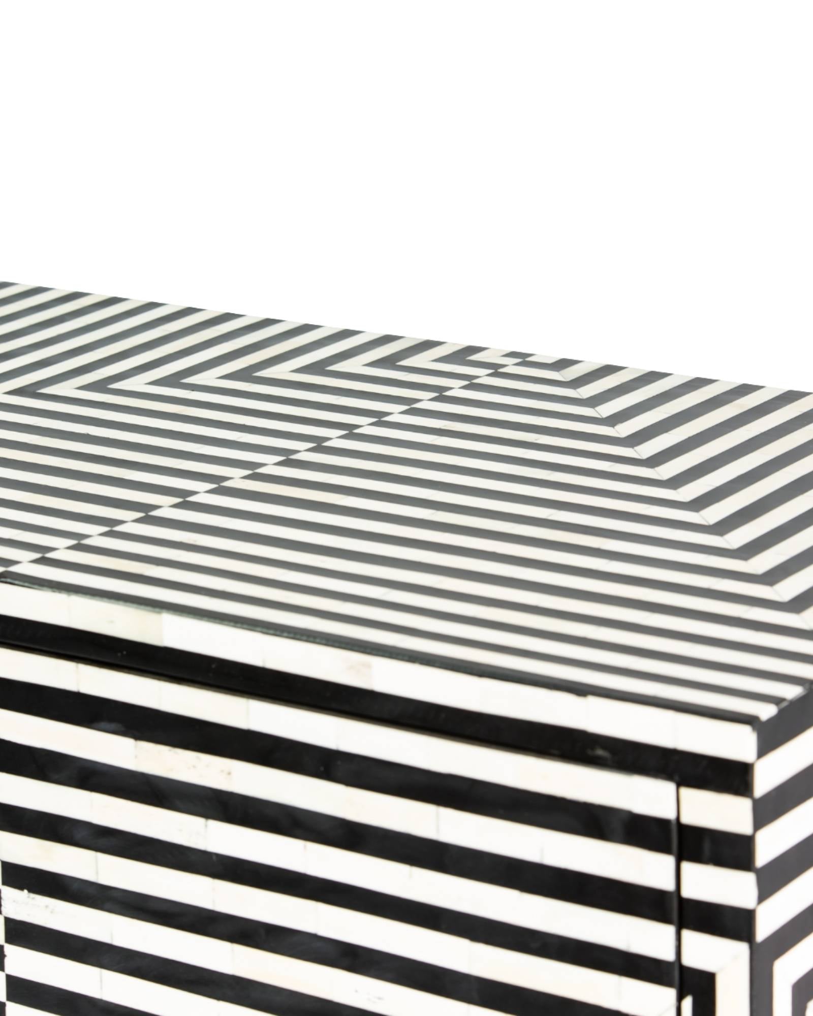 Black & White bone inlay cabinet in striped vine pattern, brass legs, and brass handles, handcrafted with spacious storage and artisanal charm.