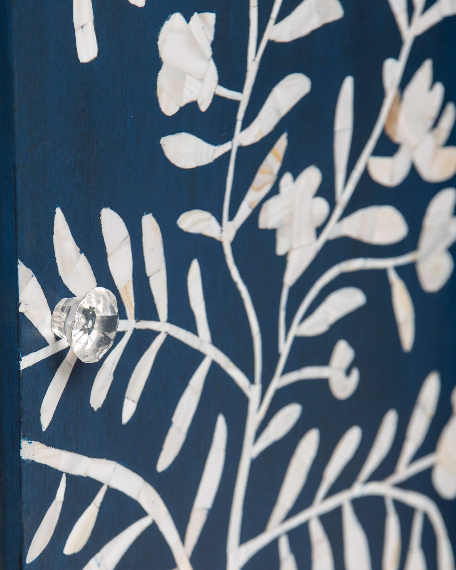 Mother of pearl inlay cabinet featuring intricate floral vine pattern in blue and white, handcrafted furniture piece.