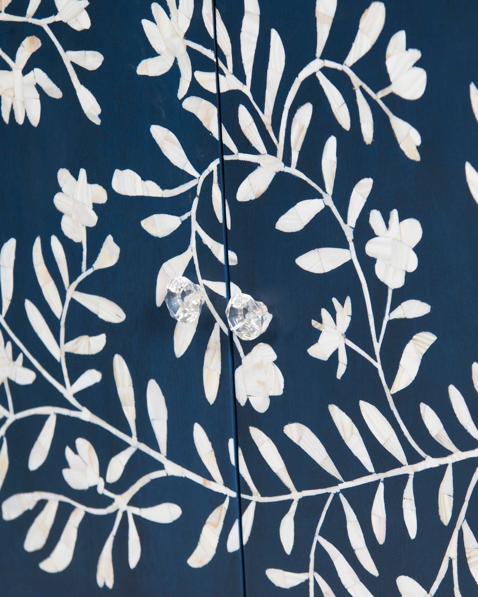 Mother of pearl inlay cabinet featuring intricate floral vine pattern in blue and white, handcrafted furniture piece.