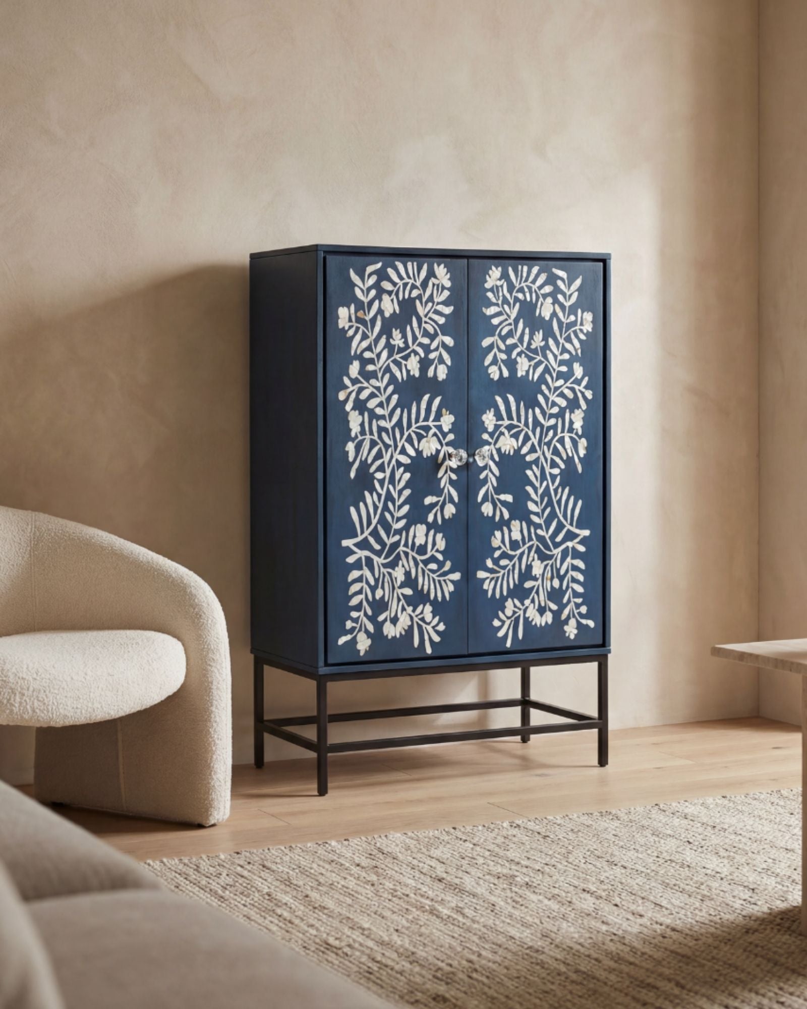 Mother of pearl inlay cabinet featuring intricate floral vine pattern in blue and white, handcrafted furniture piece.