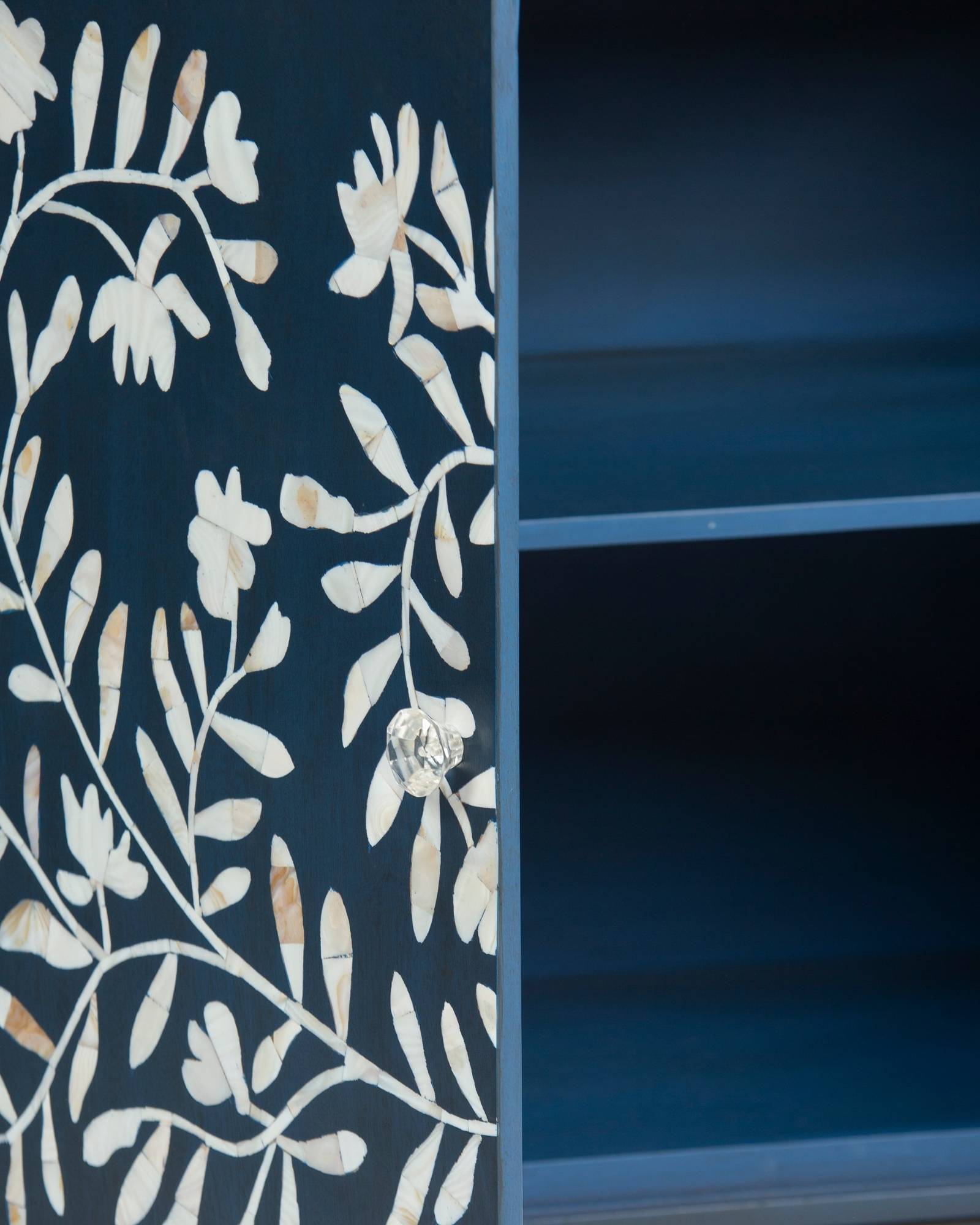 Mother of pearl inlay cabinet featuring intricate floral vine pattern in blue and white, handcrafted furniture piece.