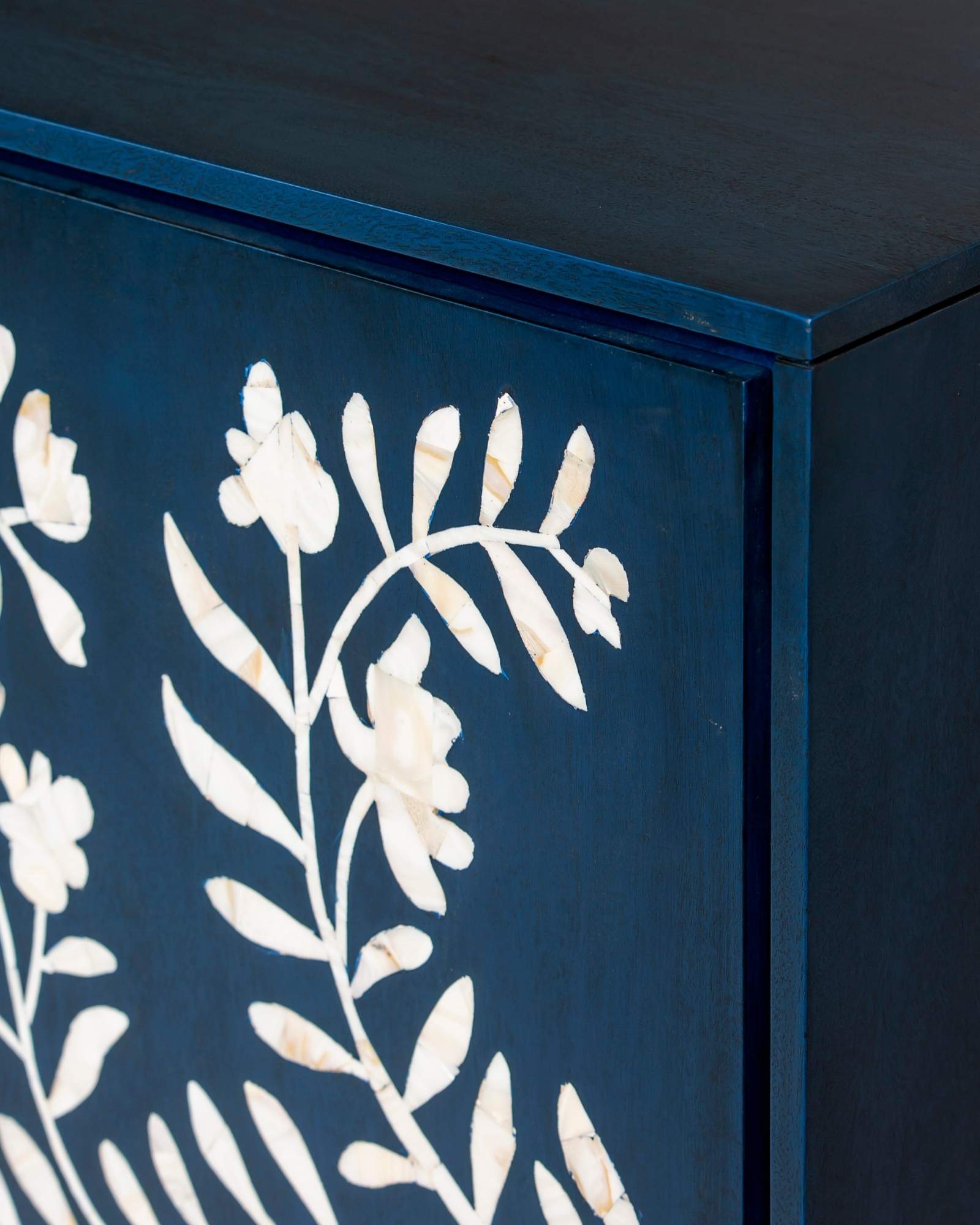 Mother of pearl inlay cabinet featuring intricate floral vine pattern in blue and white, handcrafted furniture piece.