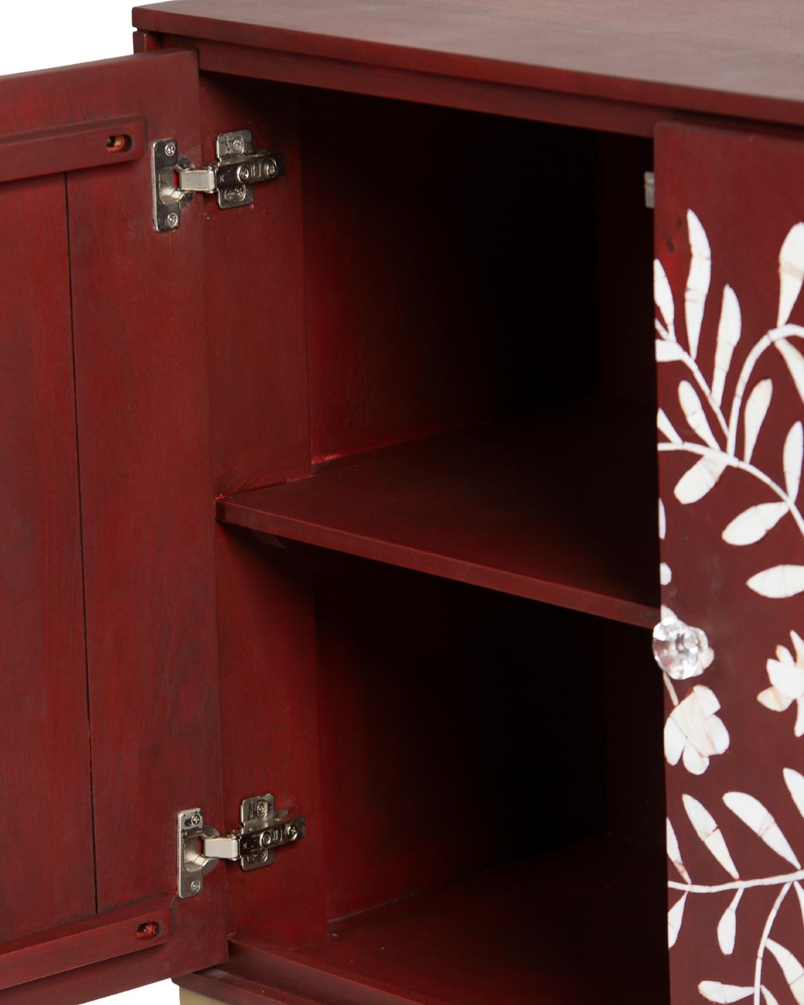 Mother of pearl inlay cabinet featuring intricate floral vine pattern in burgundy and white, handcrafted furniture piece.