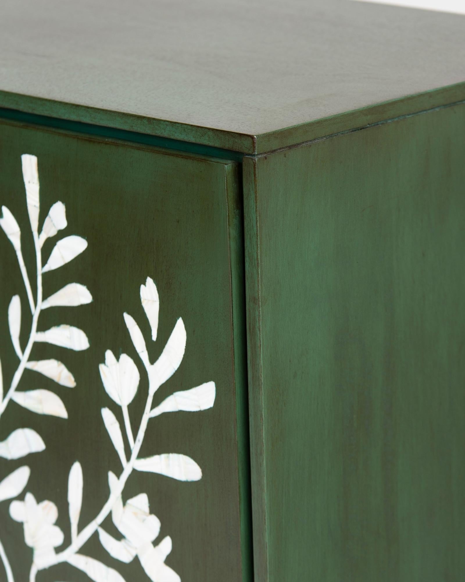 Mother of pearl inlay cabinet featuring intricate floral vine pattern in green and white, handcrafted furniture piece.