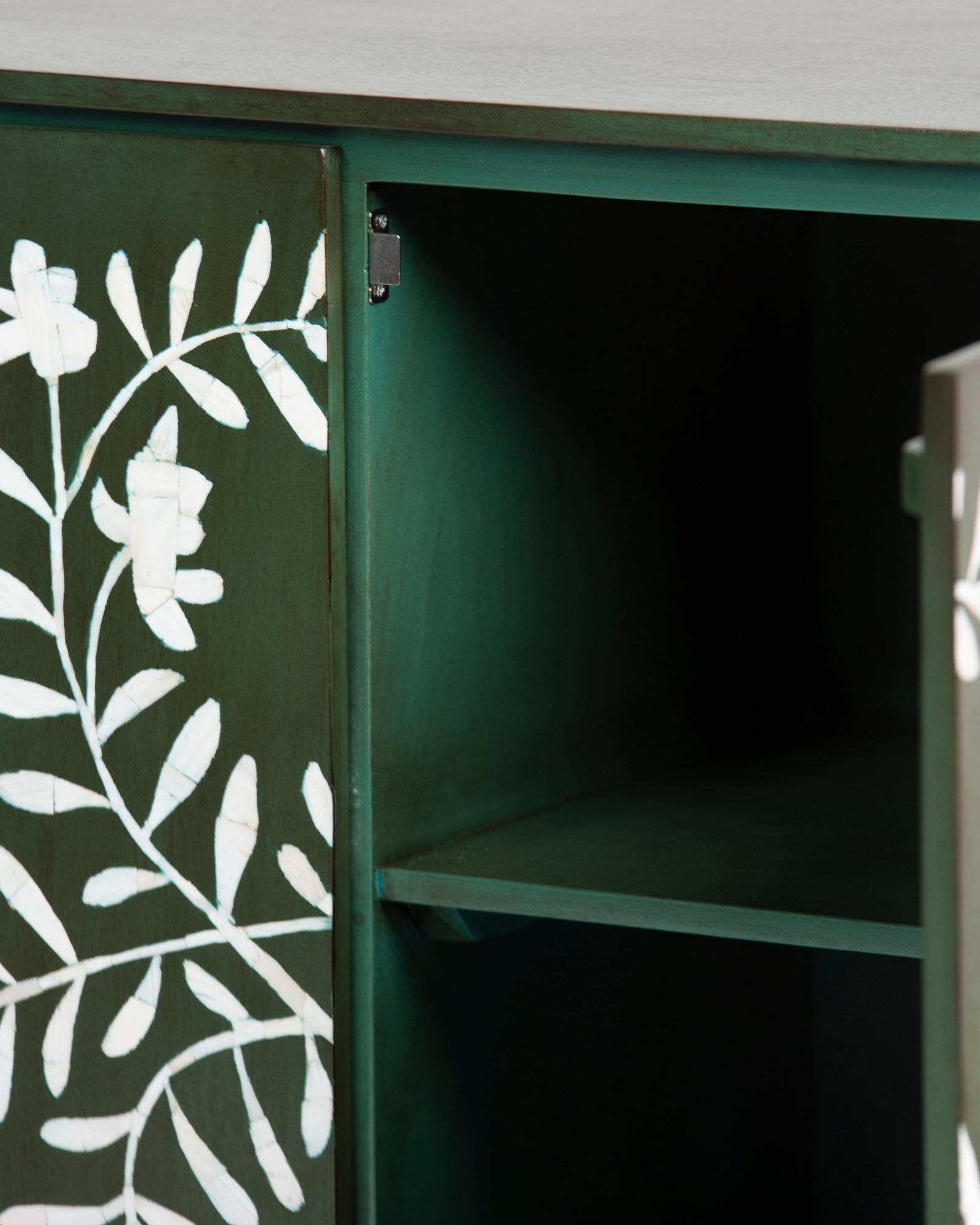 Mother of pearl inlay cabinet featuring intricate floral vine pattern in green and white, handcrafted furniture piece.