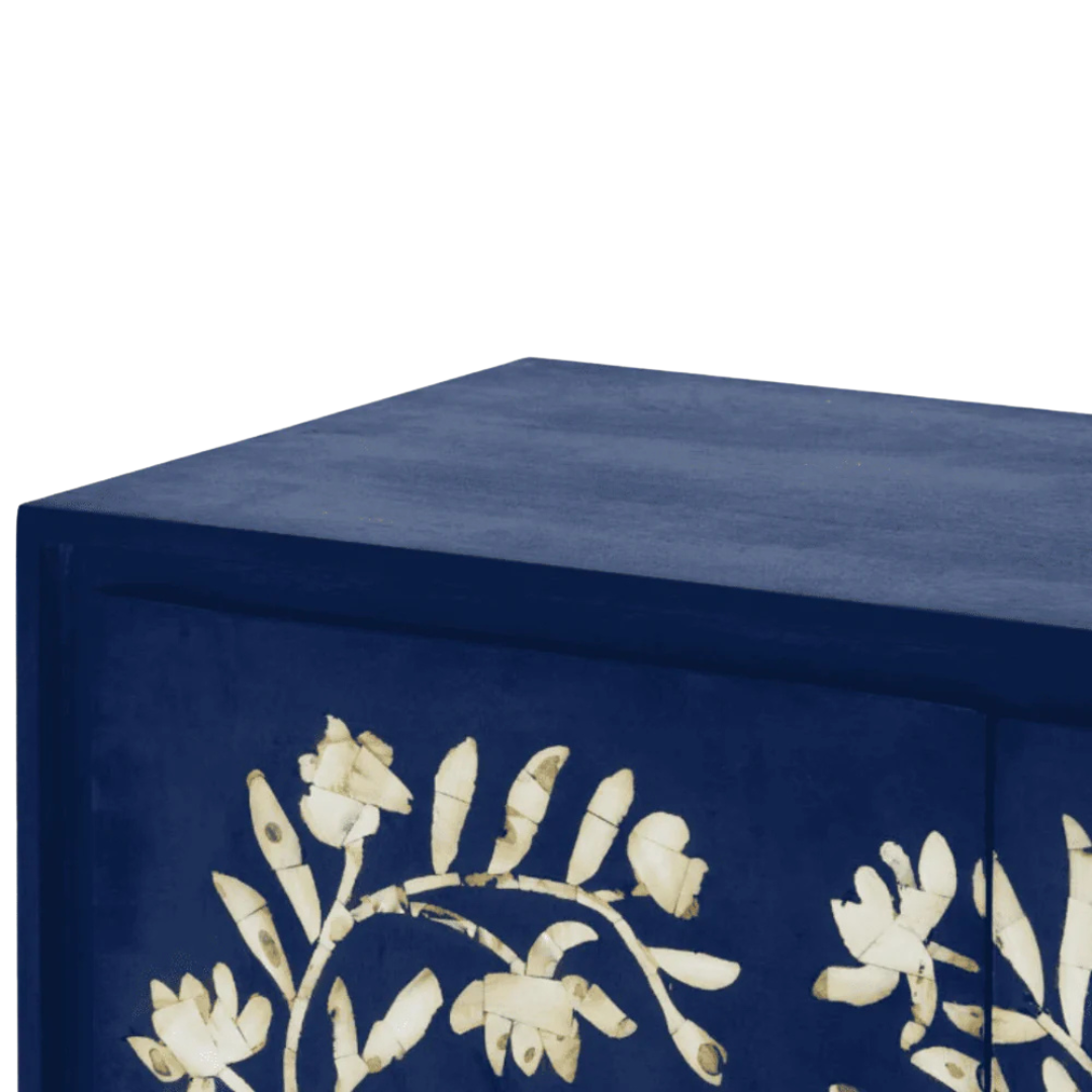 Handcrafted blue cabinet with intricate mother-of-pearl inlay, featuring a floral pattern and sleek metal legs. A luxurious storage solution for any space.
