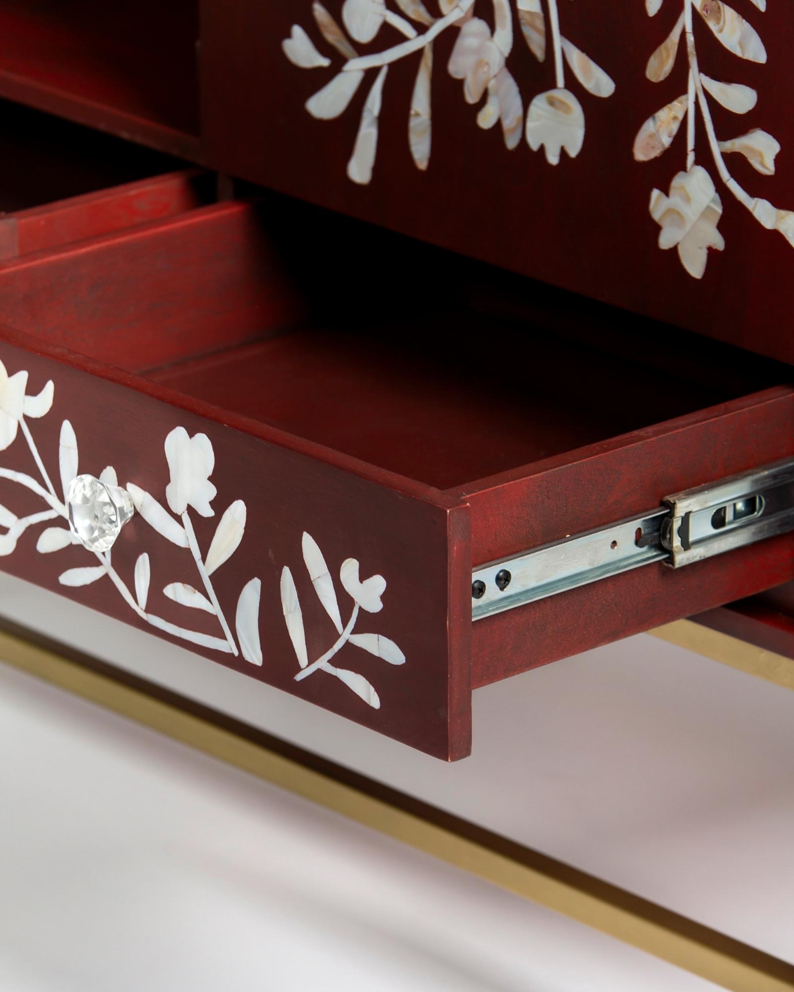 Mother of pearl inlay cabinet featuring intricate floral vine pattern in burgundy and white, handcrafted furniture piece.