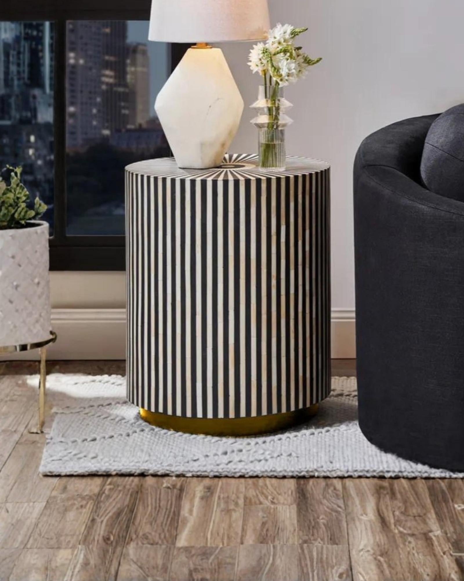 Black bone inlay side table with a striking striped pattern and round top, adding elegance.