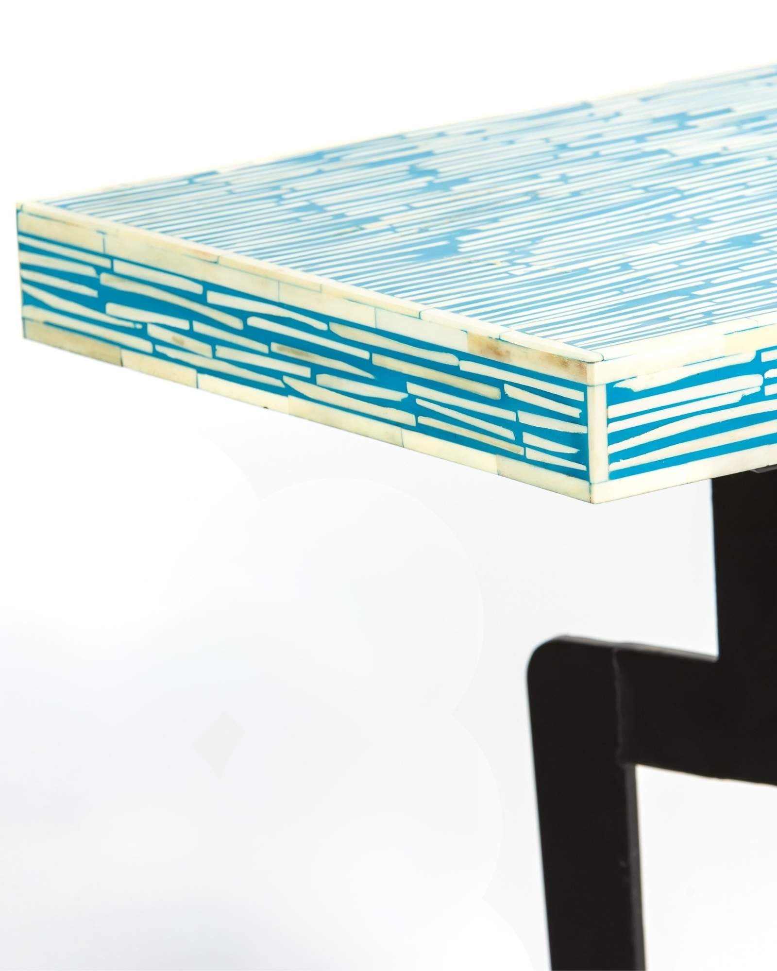 Modern console table with a blue and white patterned top on a white background.