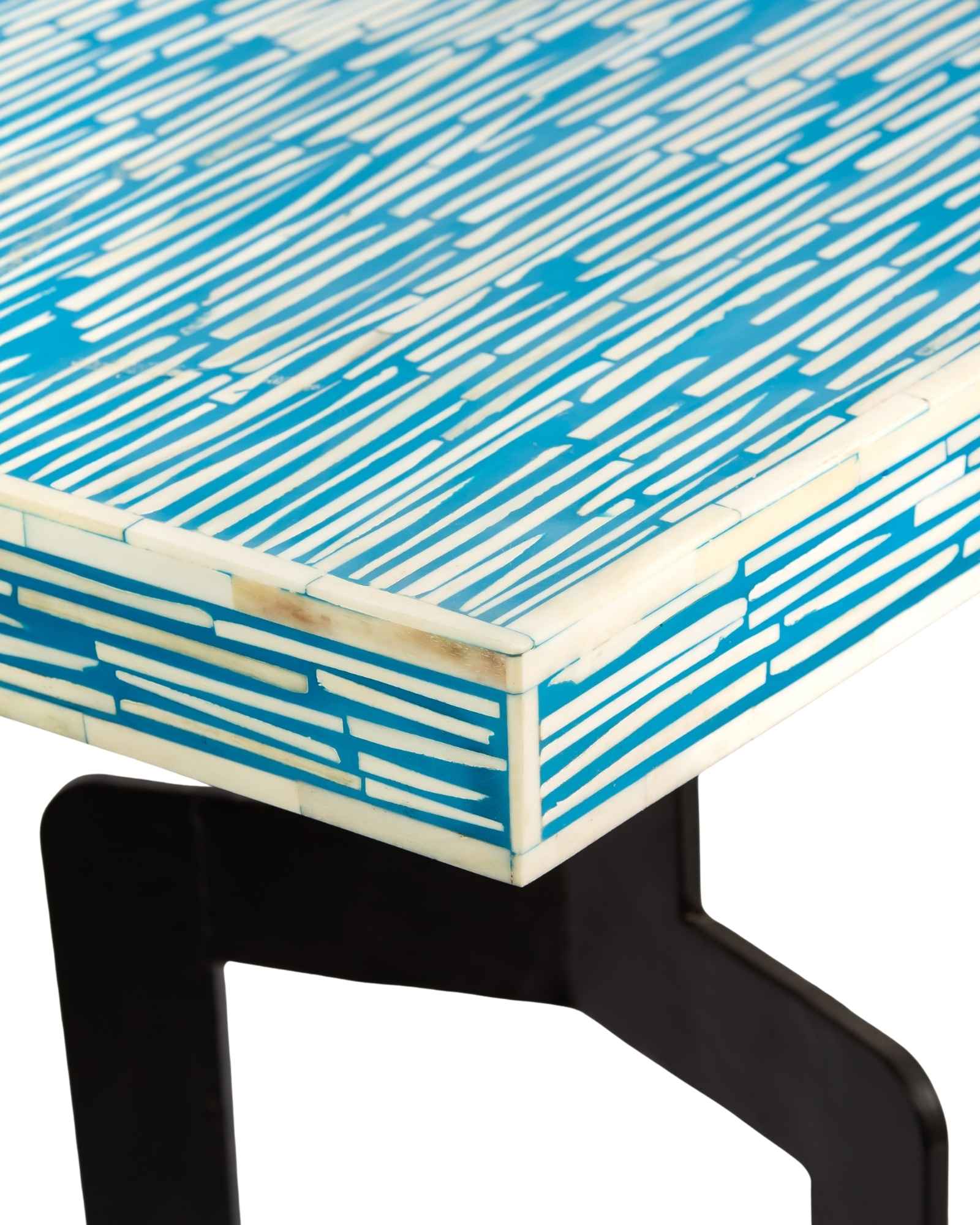 Modern console table with a blue and white patterned top on a white background.