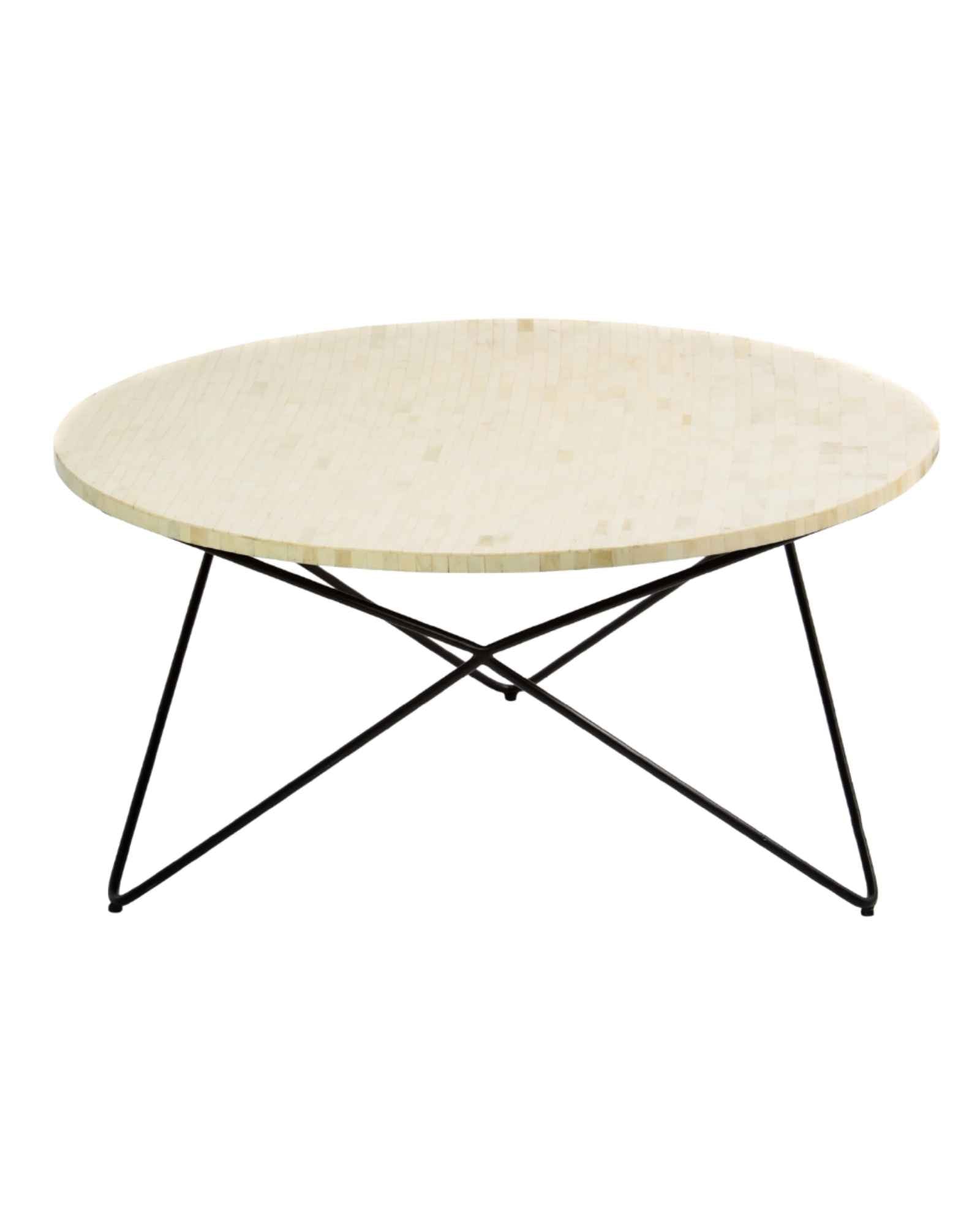 Ivory bone carved coffee table with linear textured surface and angular black metal base by Tabeer Homes.