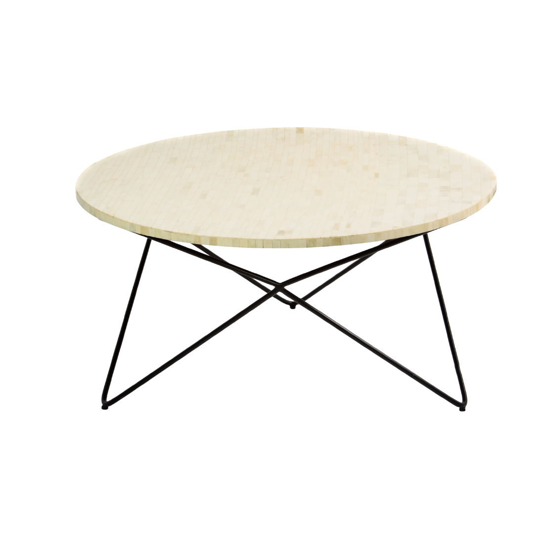 Ivory bone carved coffee table with linear textured surface and angular black metal base by Tabeer Homes.