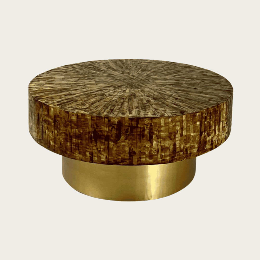 Round brown mother of pearl inlay coffee table with a rich textured surface and bold gold base. A luxurious centerpiece for living spaces.