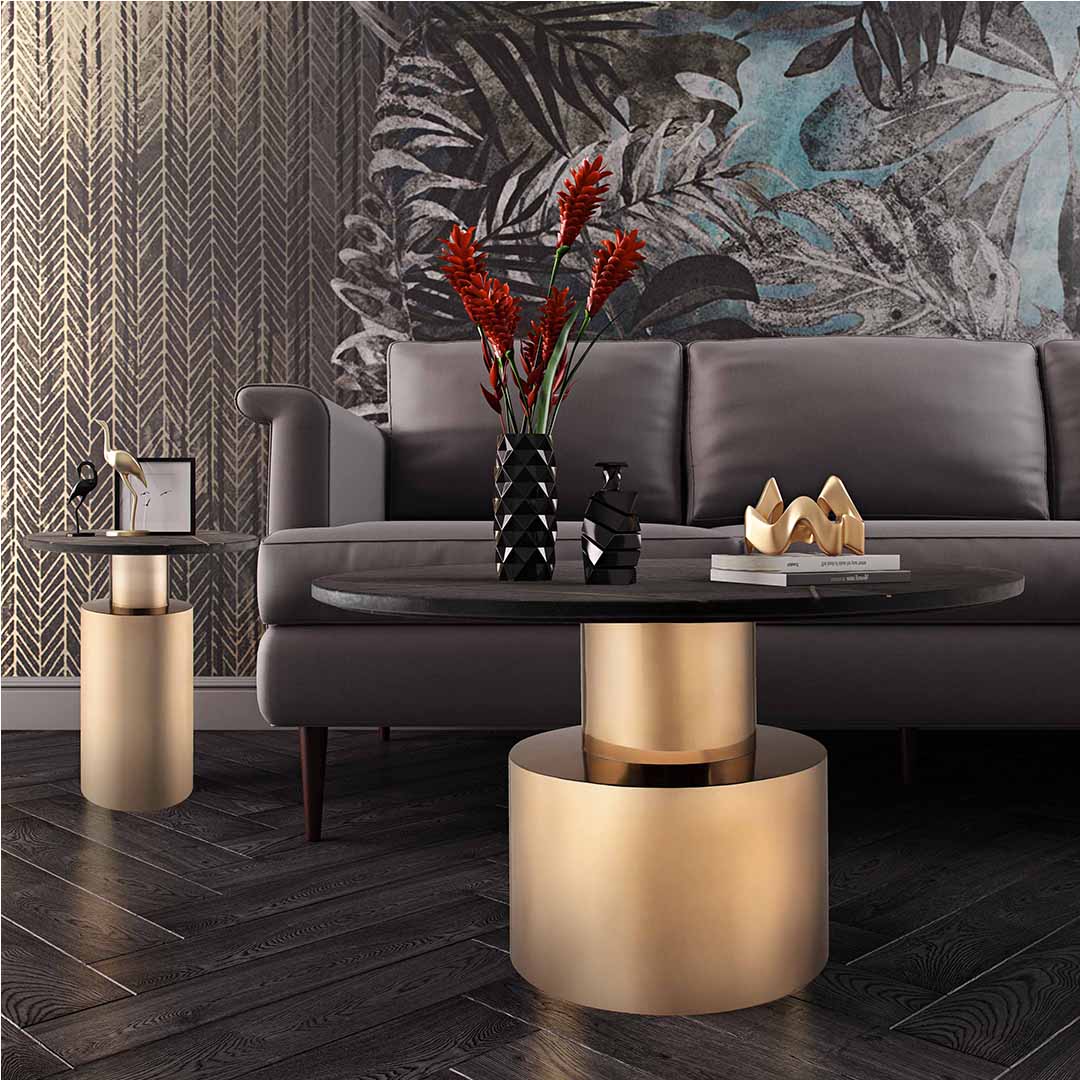 Round black marble coffee table with subtle gold inlay accents and a bold cylindrical gold-finished metallic base.