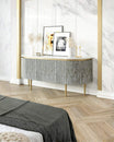 Black bone inlay sideboard with white marble top and brass legs, handcrafted with vertical striping and curved silhouette, luxury interior furniture.
