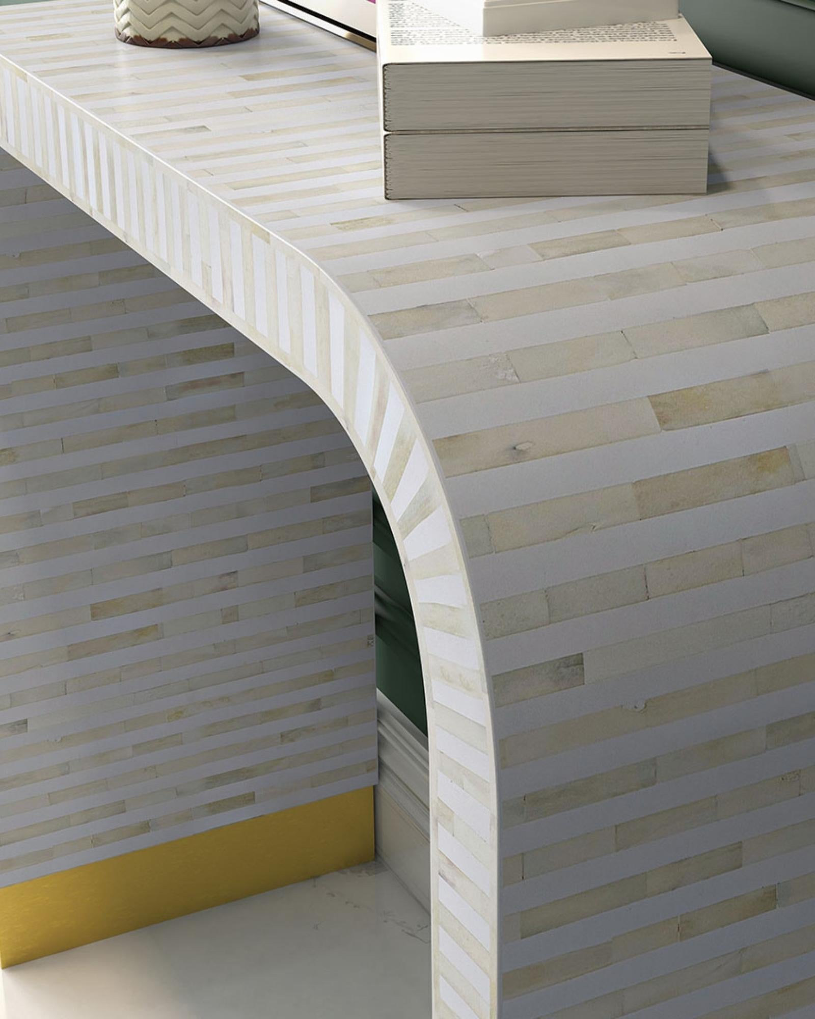 Elegant white bone inlay console with intricate detailing and a modern curved silhouette.