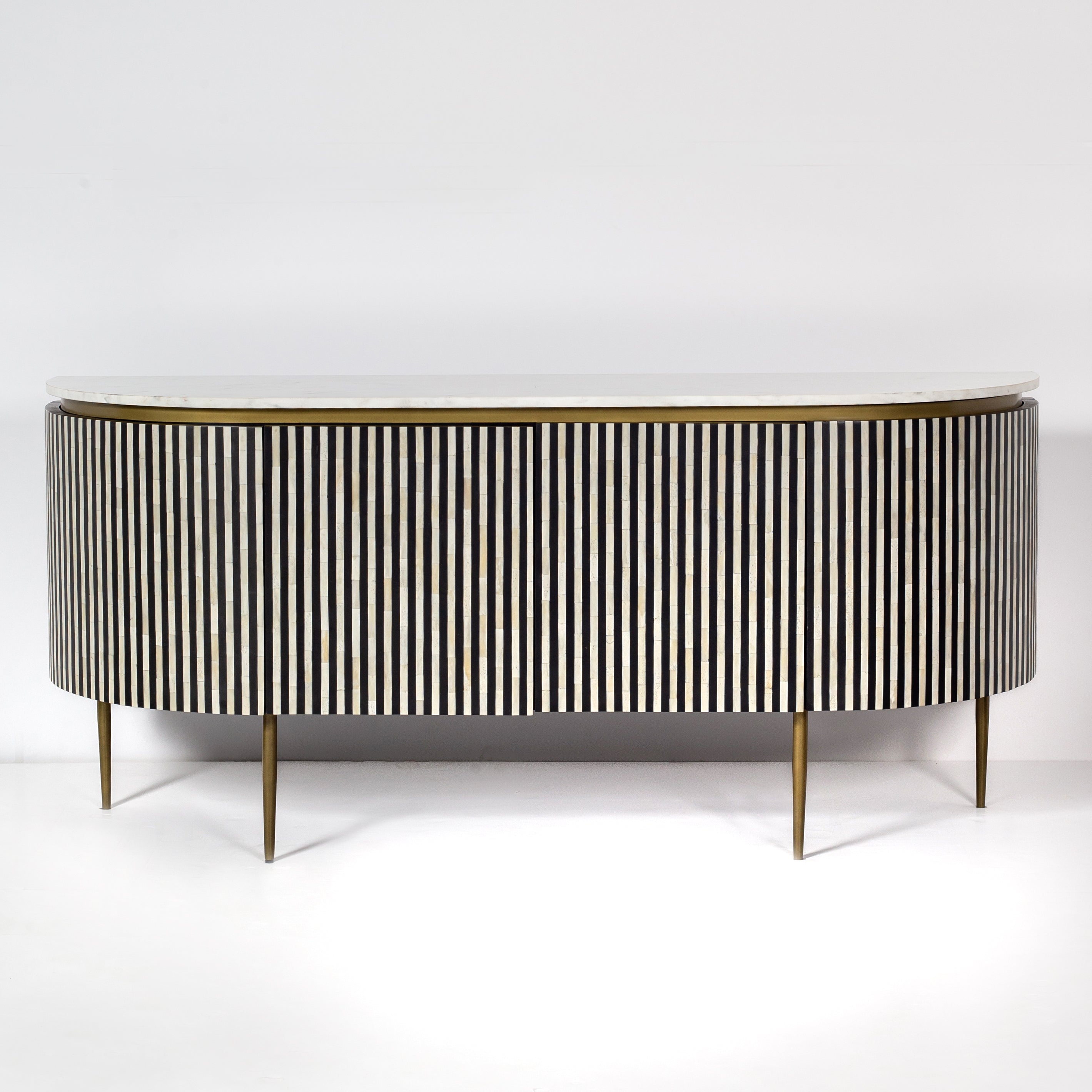 Black bone inlay sideboard with white marble top and brass legs, handcrafted with vertical striping and curved silhouette, luxury interior furniture.