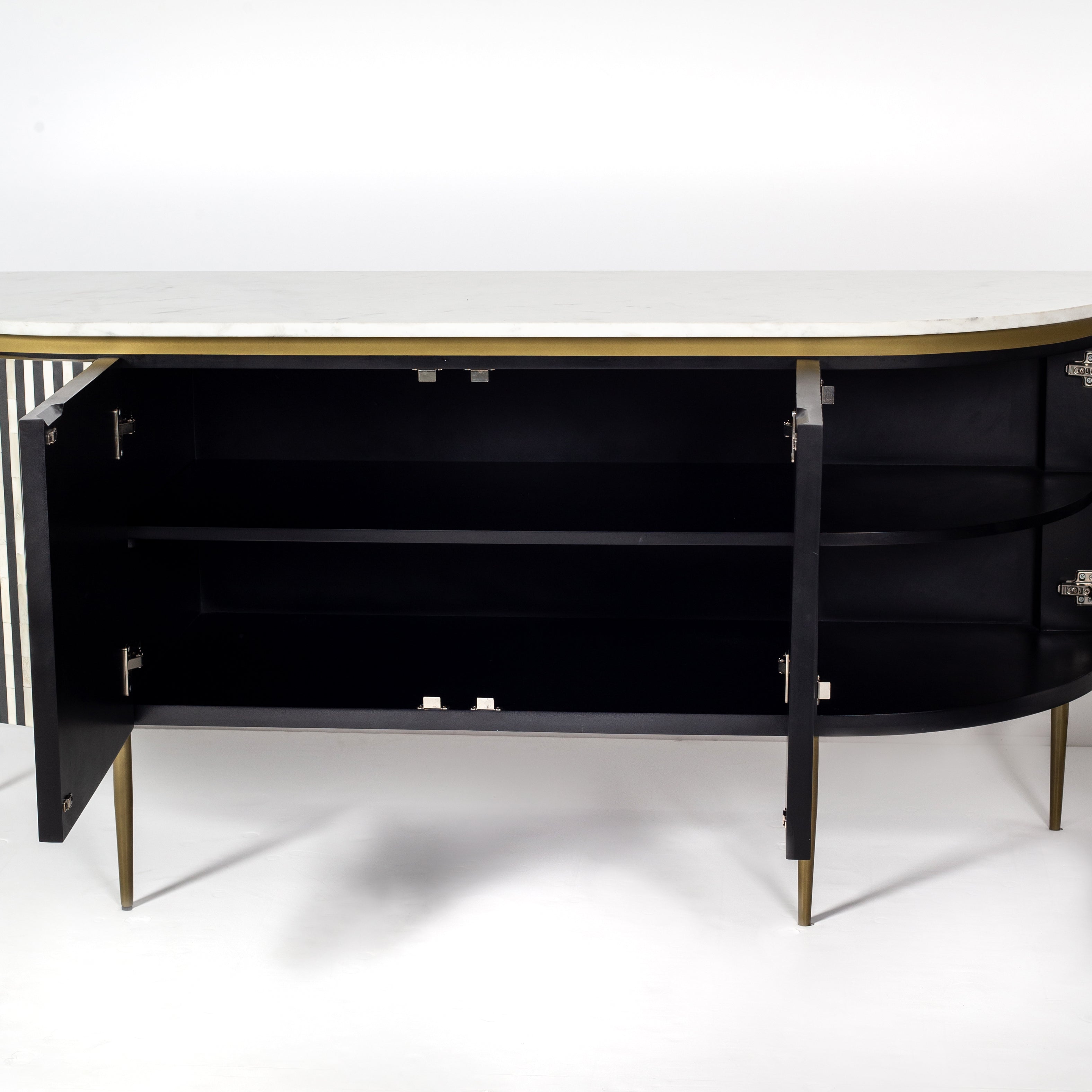 Black bone inlay sideboard with white marble top and brass legs, handcrafted with vertical striping and curved silhouette, luxury interior furniture.
