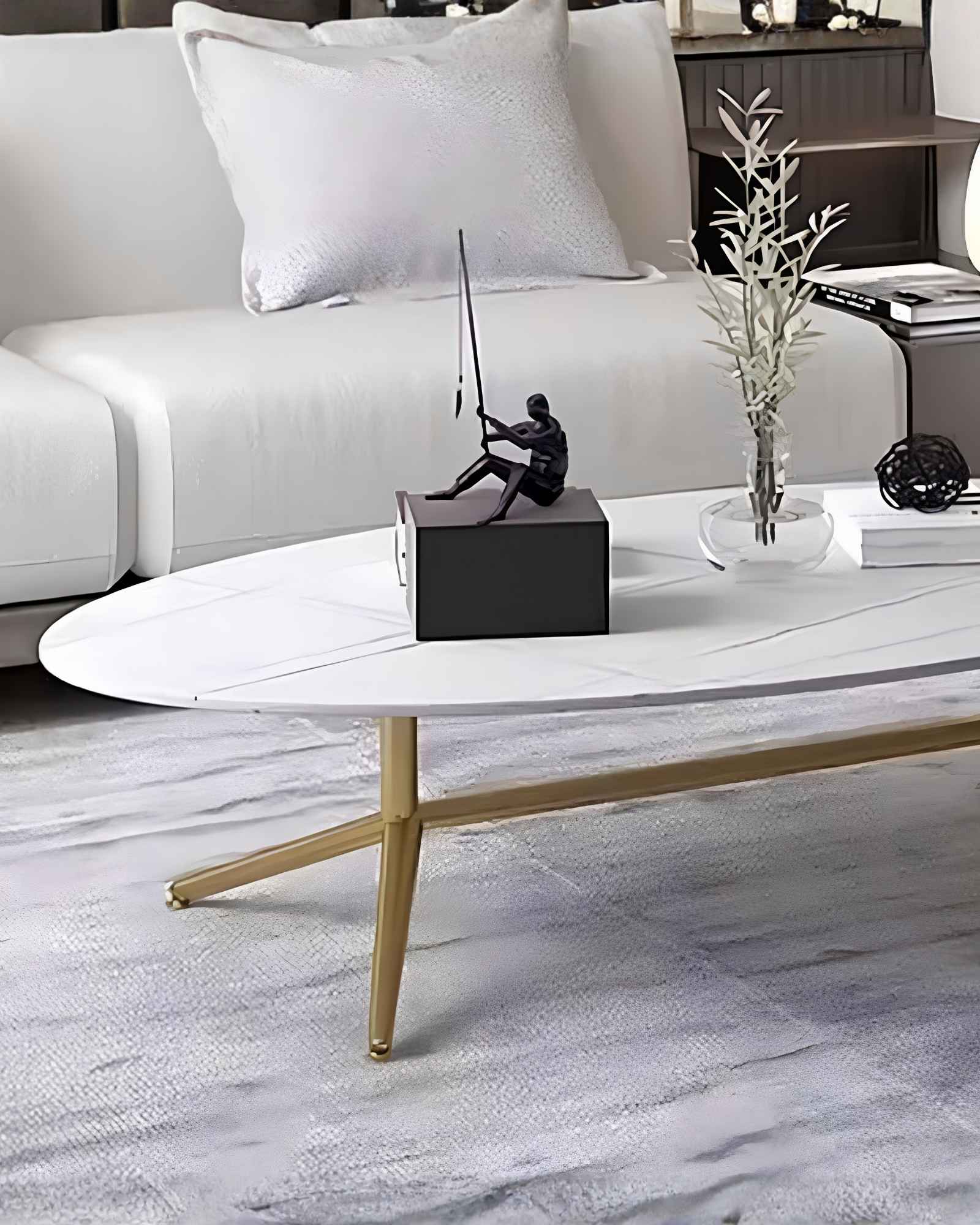 Oval white marble coffee table with subtle gold vein detailing and sleek gold legs. A modern and elegant addition to any living space.