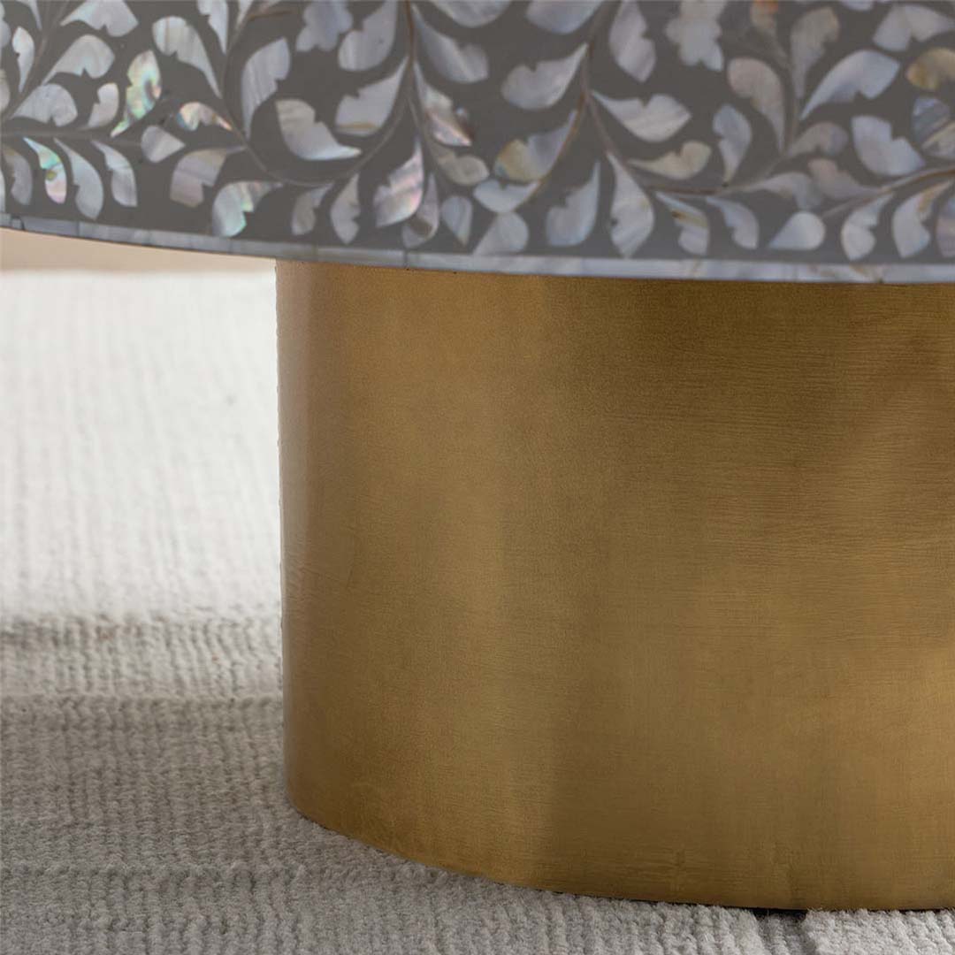 Round grey mother of pearl inlay coffee table with intricate floral design and a gold cylindrical metallic base.