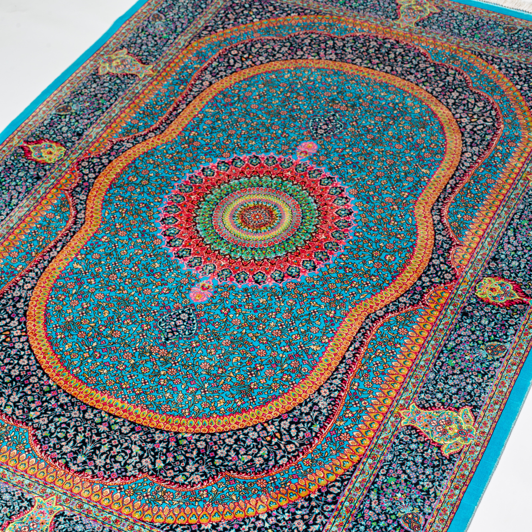 Vortex Silk Rug featuring a central floral medallion on a turquoise base with red, green, and black detailing, size 150x100 cm.
