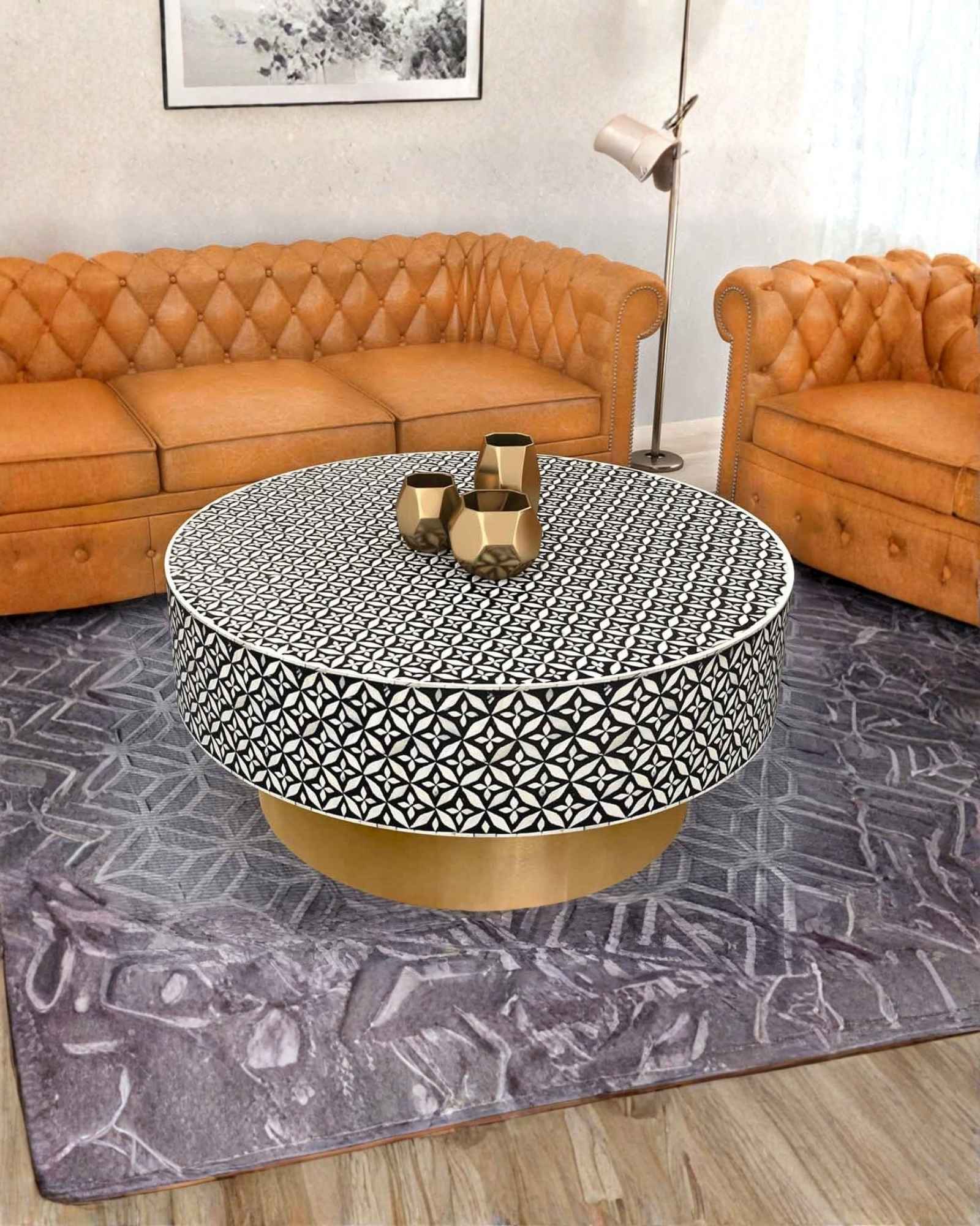 Round black bone inlay coffee table with intricate floral pattern and bold gold base. A modern, stylish centerpiece for any room.