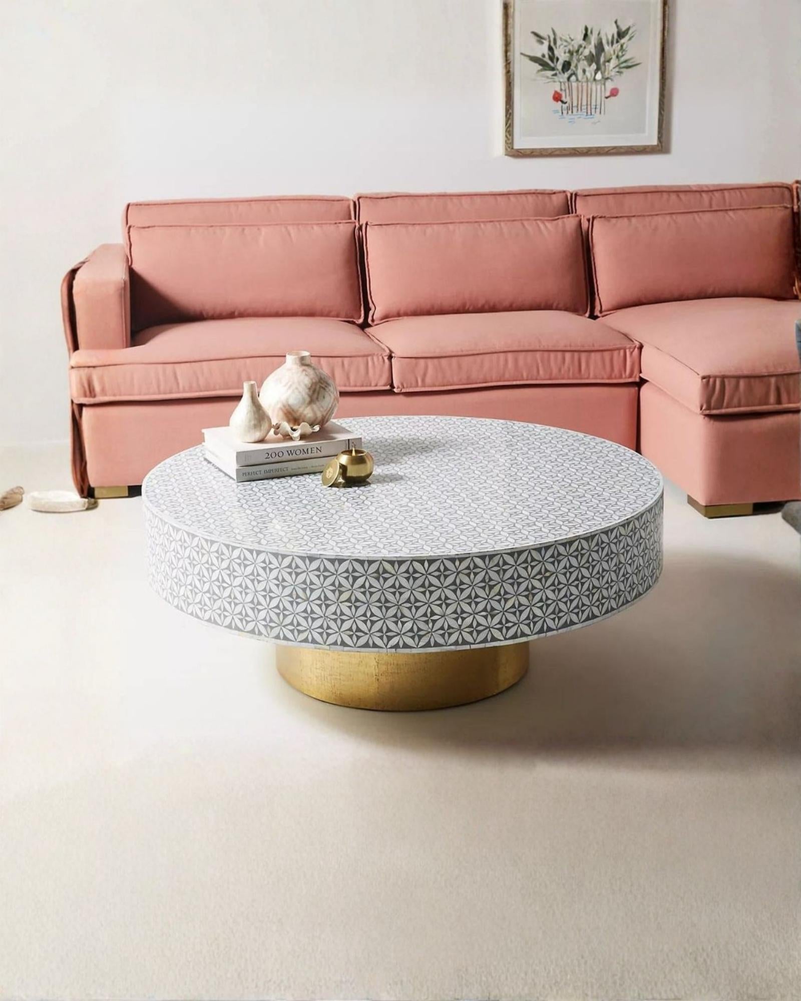 Round grey bone inlay coffee table with floral design and a bold gold base. A stylish and modern centerpiece for any living room.