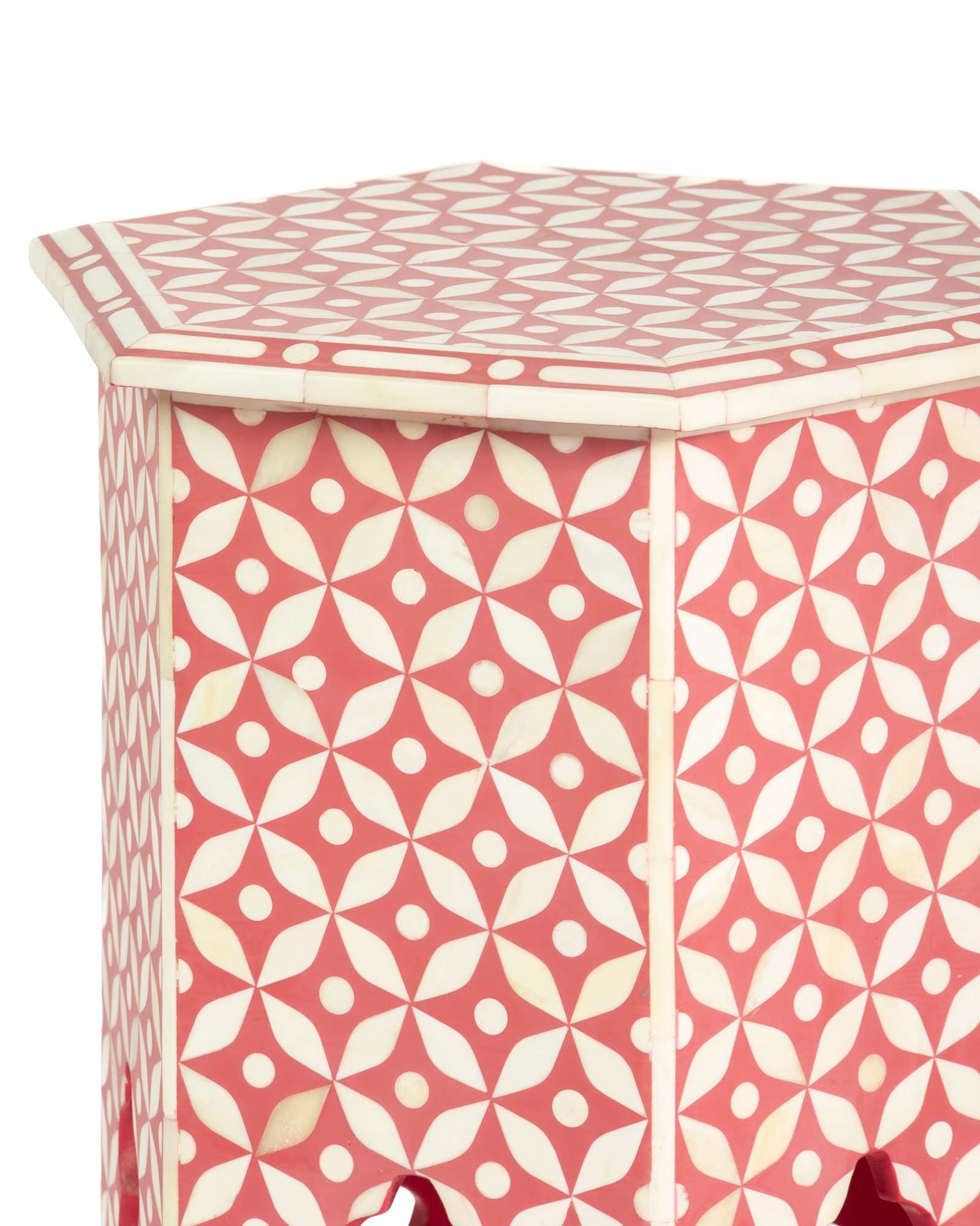 Handcrafted Yasmine side table featuring pink bone inlay with a hexagonal silhouette, geometric detailing, and arched legs.