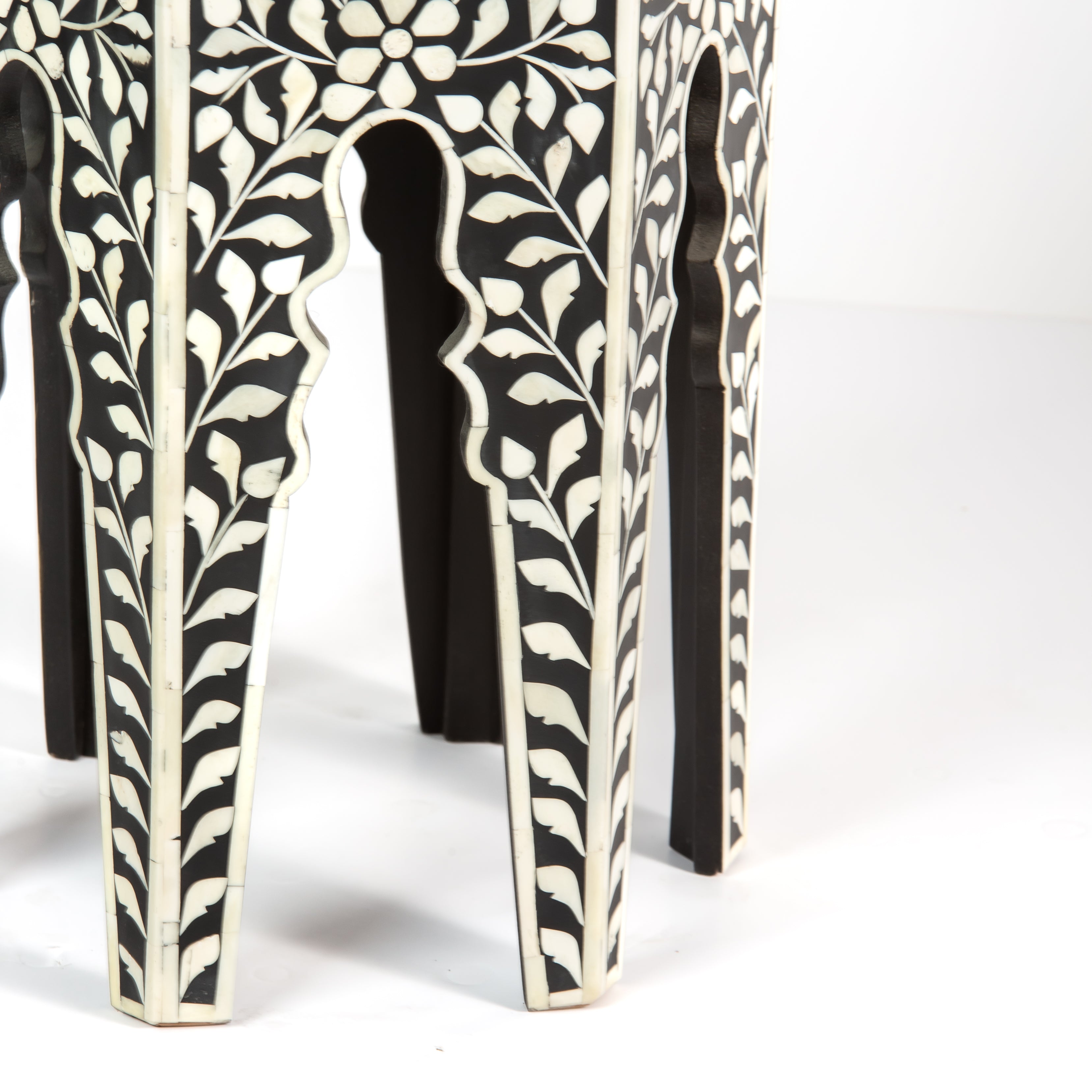 Handcrafted Yasmine side table in black bone inlay with a hexagonal form and arched legs, perfect as a refined accent piece.