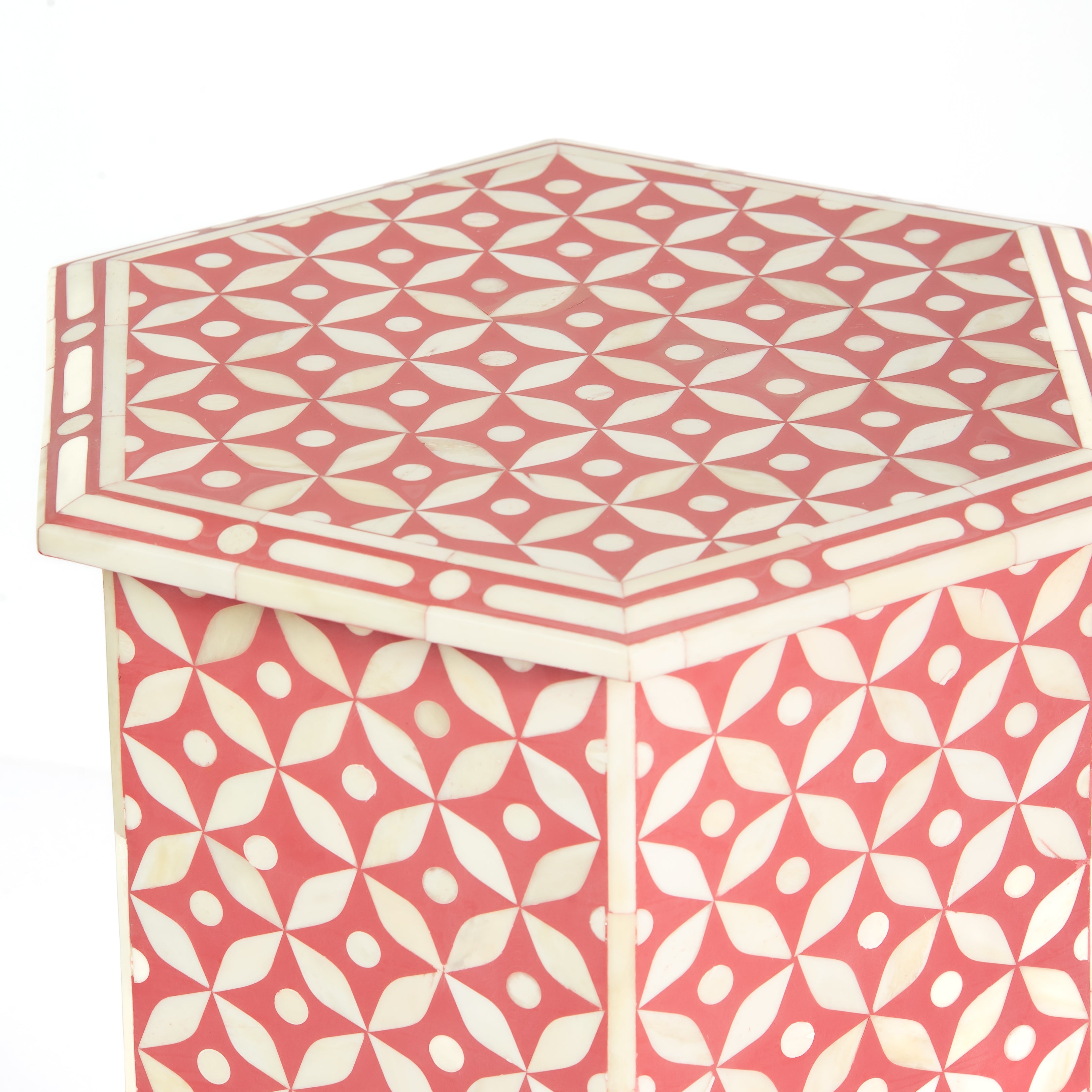 Handcrafted Yasmine side table featuring pink bone inlay with a hexagonal silhouette, geometric detailing, and arched legs.