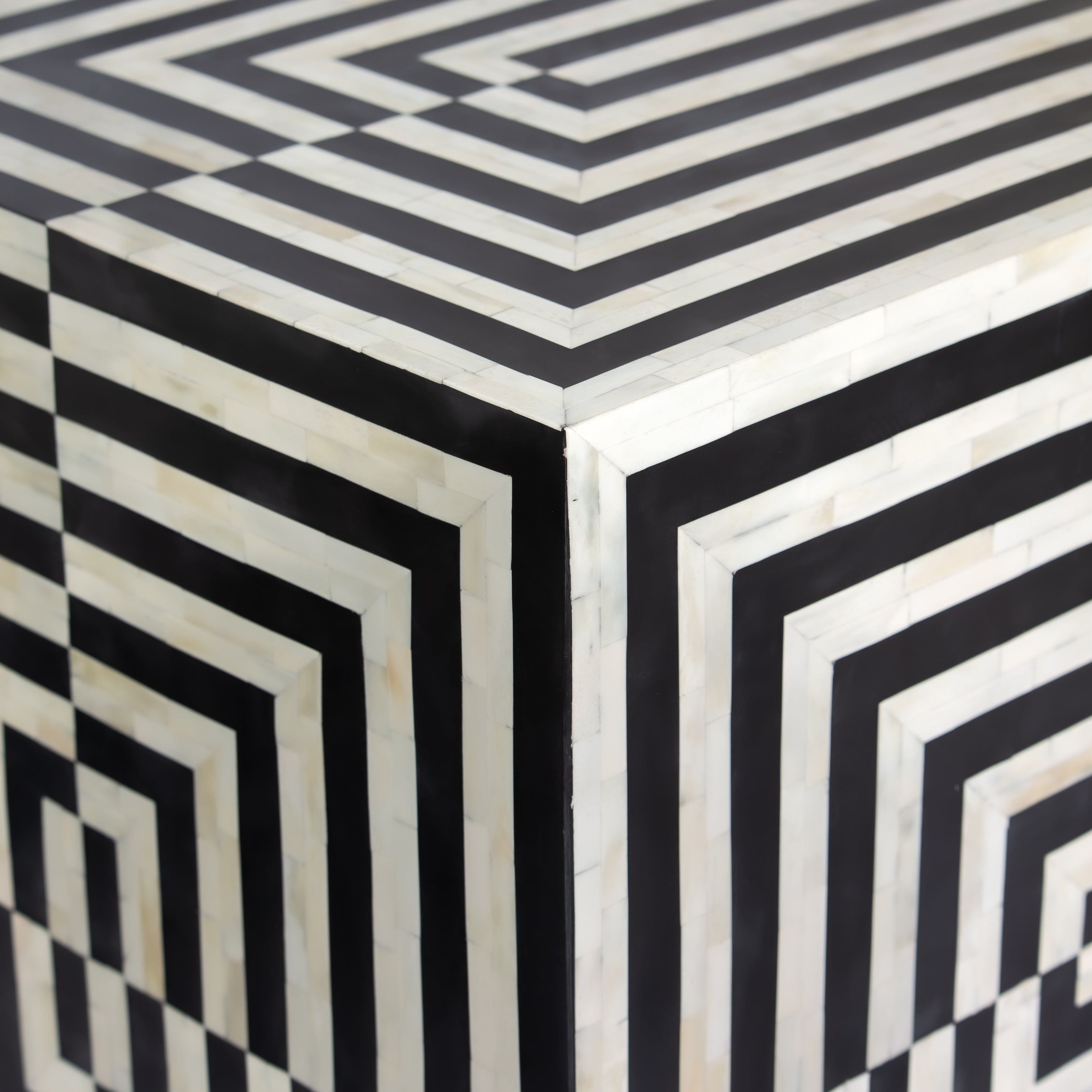 Black bone inlay bar cabinet with bold geometric front and open back storage, handmade with brass base and striking design.
