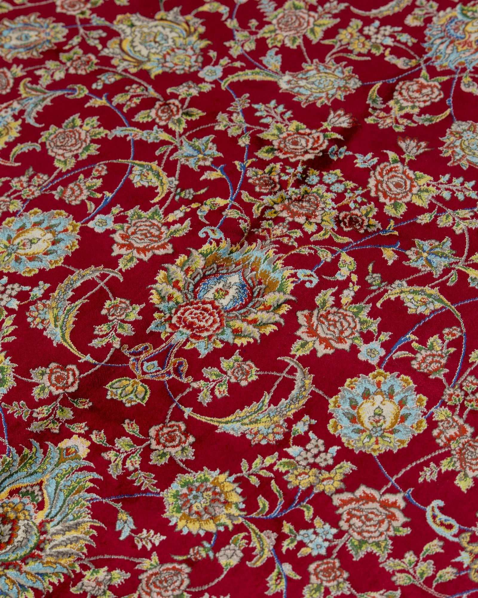 Alessia silk carpet angled view showing ruby red tones, 200 x 300 cm - Tabeer Homes Dubai
